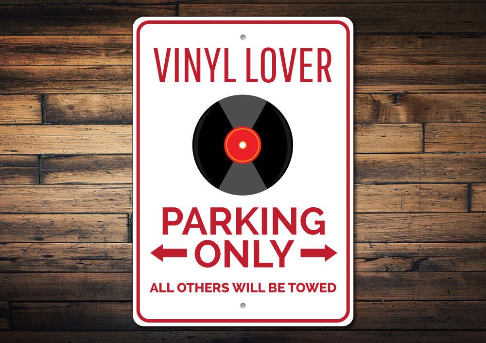 Vinyl Lover Parking Sign made of durable aluminum with a unique design, featuring pre-drilled holes for easy mounting.