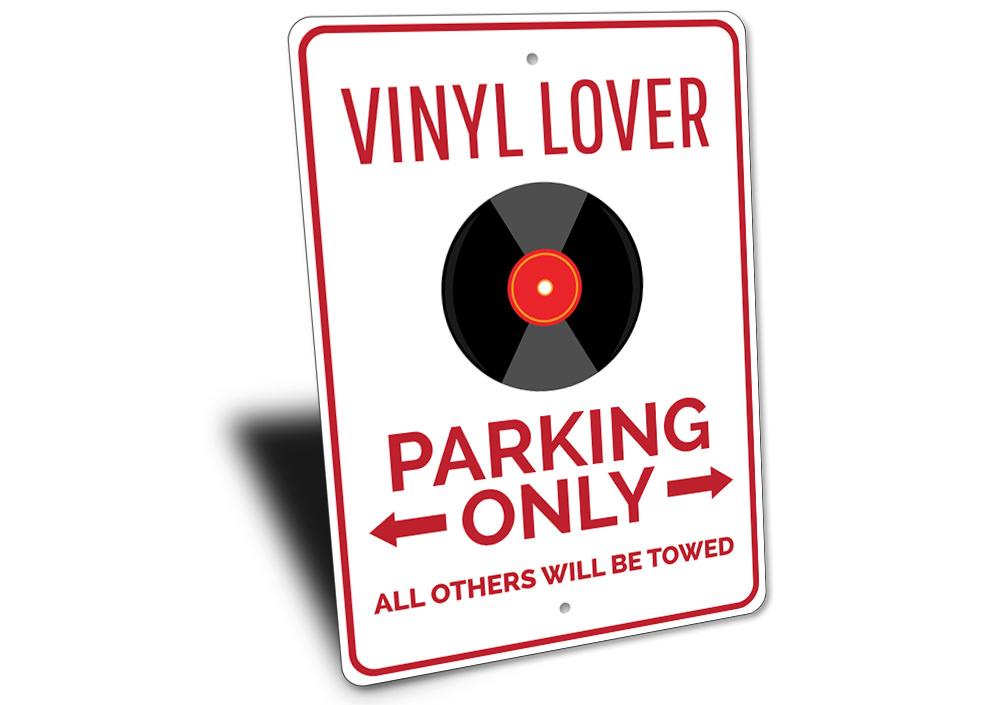 Vinyl Lover Parking Sign made of durable aluminum with a unique design, featuring pre-drilled holes for easy mounting.