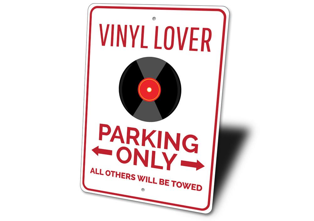 Vinyl Lover Parking Sign made of durable aluminum with a unique design, featuring pre-drilled holes for easy mounting.