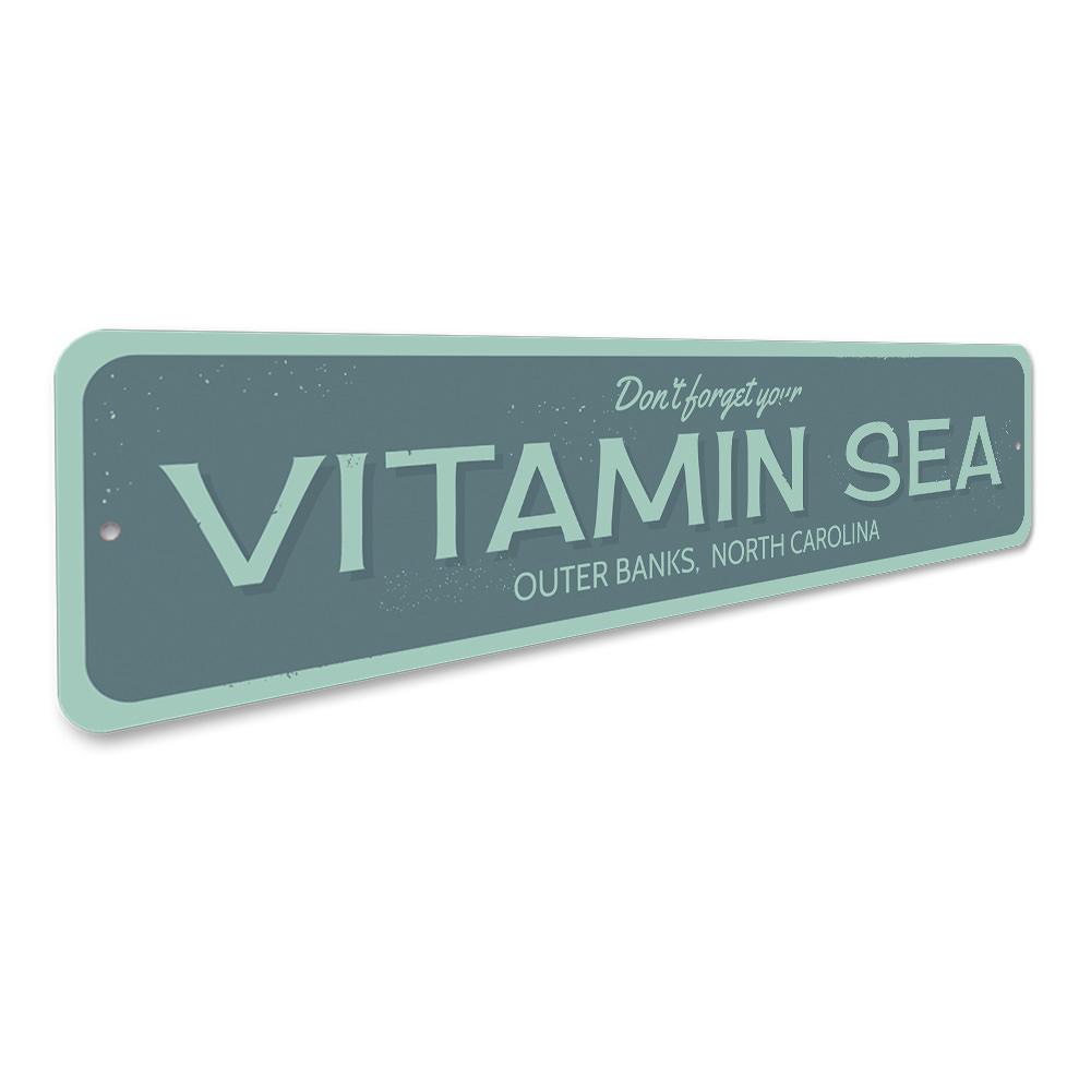 A decorative Vitamin Sea sign made of high-quality aluminum, featuring a beach-themed design, perfect for coastal decor.