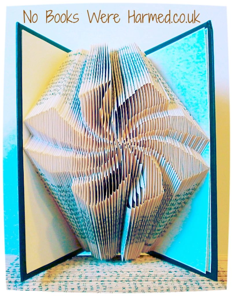 A unique handcrafted Vortex art piece made from vintage books, showcasing intricate hand-folded designs in various colors.