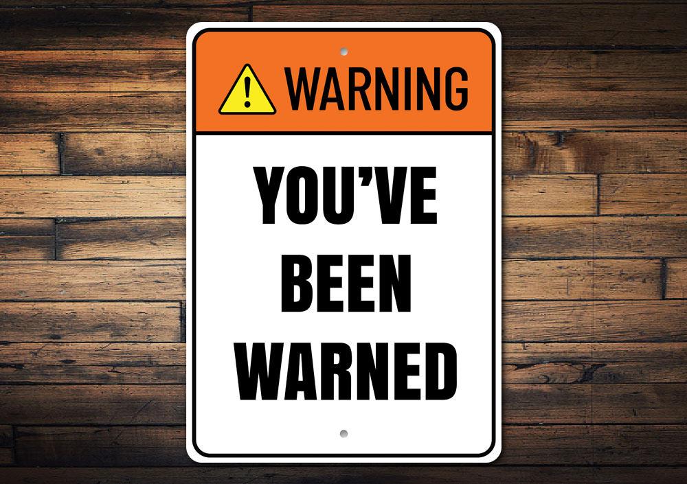 A decorative 'Warning You've Been Warned' sign made of high-quality aluminum, featuring bold lettering and a stylish design, perfect for home decor.