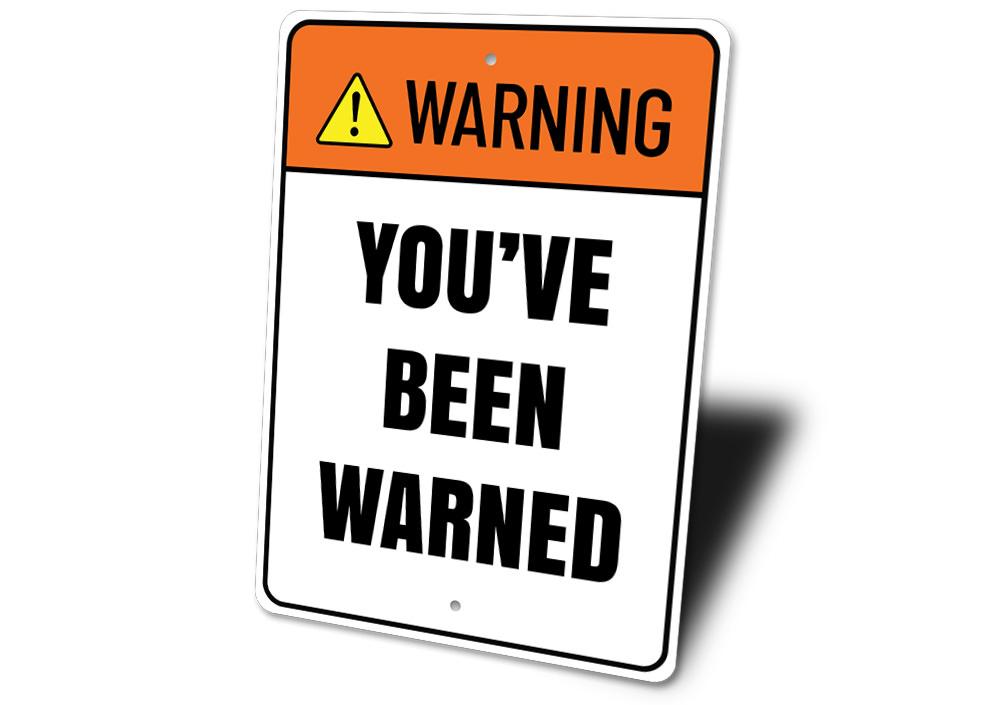 A decorative 'Warning You've Been Warned' sign made of high-quality aluminum, featuring bold lettering and a stylish design, perfect for home decor.