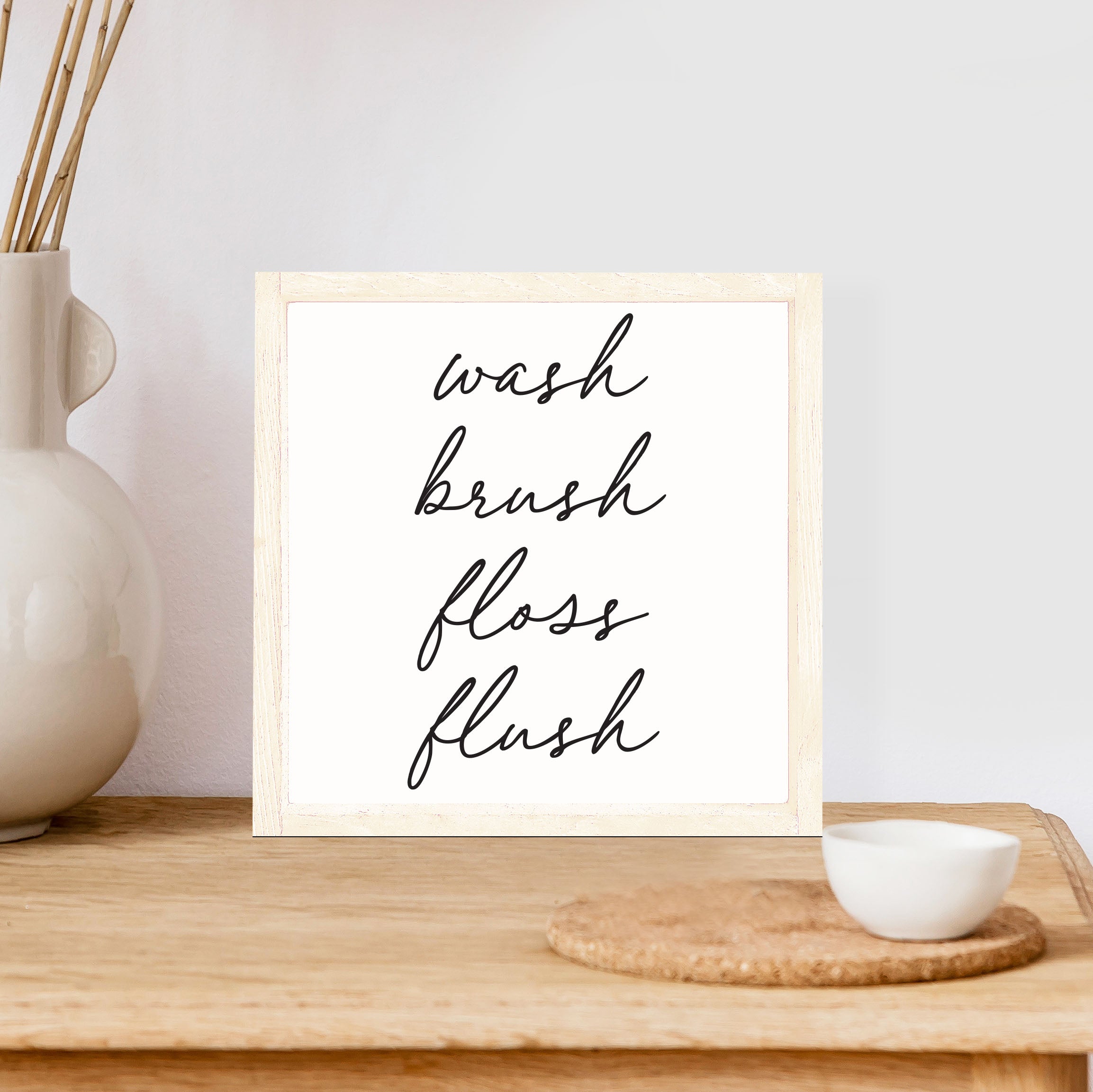 Wash Brush Floss Flush Wood Sign with a rustic wood frame and waterproof black text on a white background, measuring 8x8 inches.