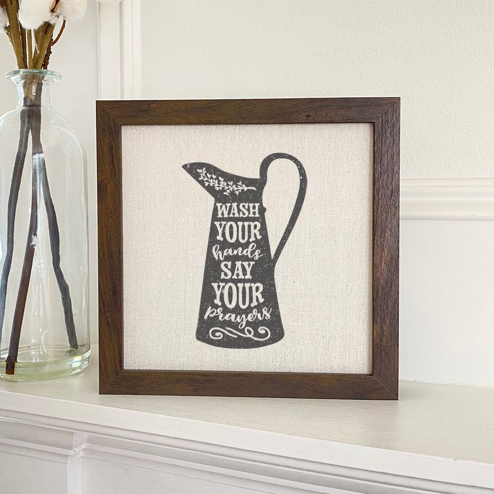 Wash Your Hands Pitcher sign with a stylish wood frame and linen-look background, perfect for home or office decor.