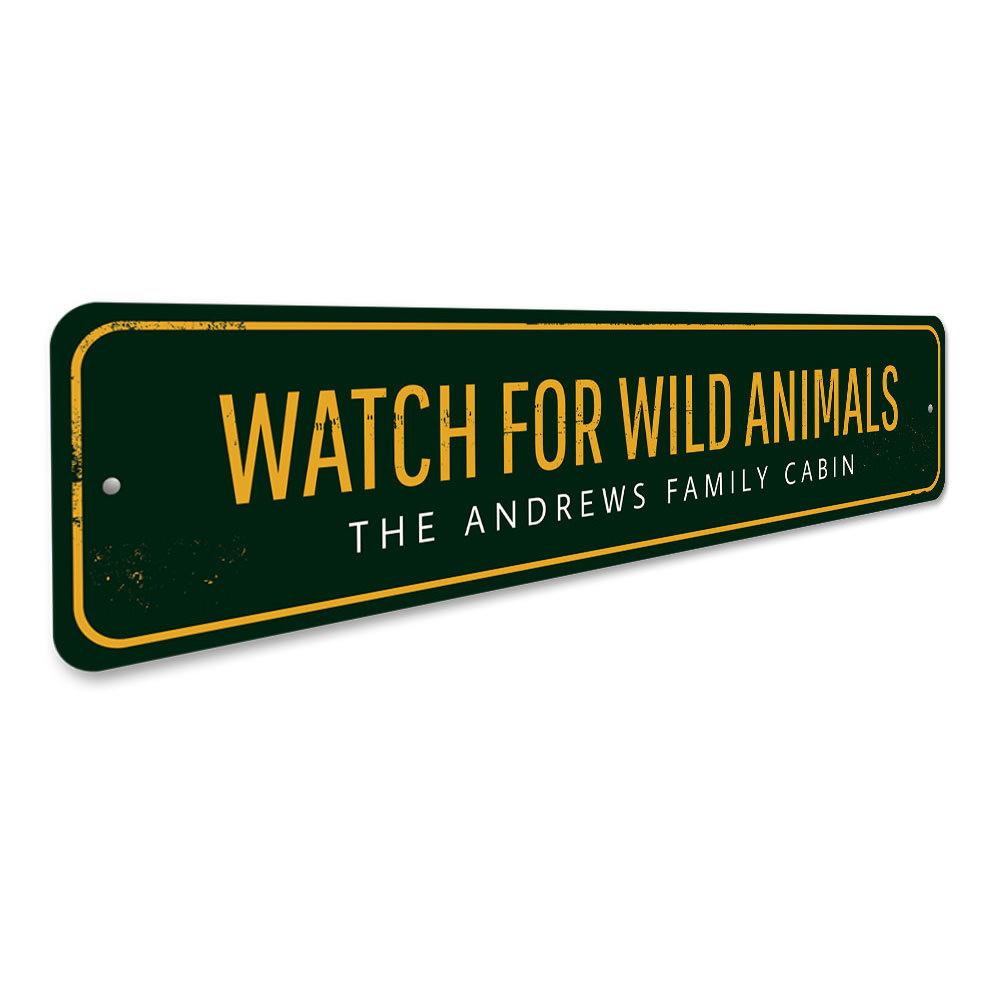 A decorative 'Watch For Wild Animals' sign made of durable aluminum, featuring customizable text, ideal for lakehouse decor.