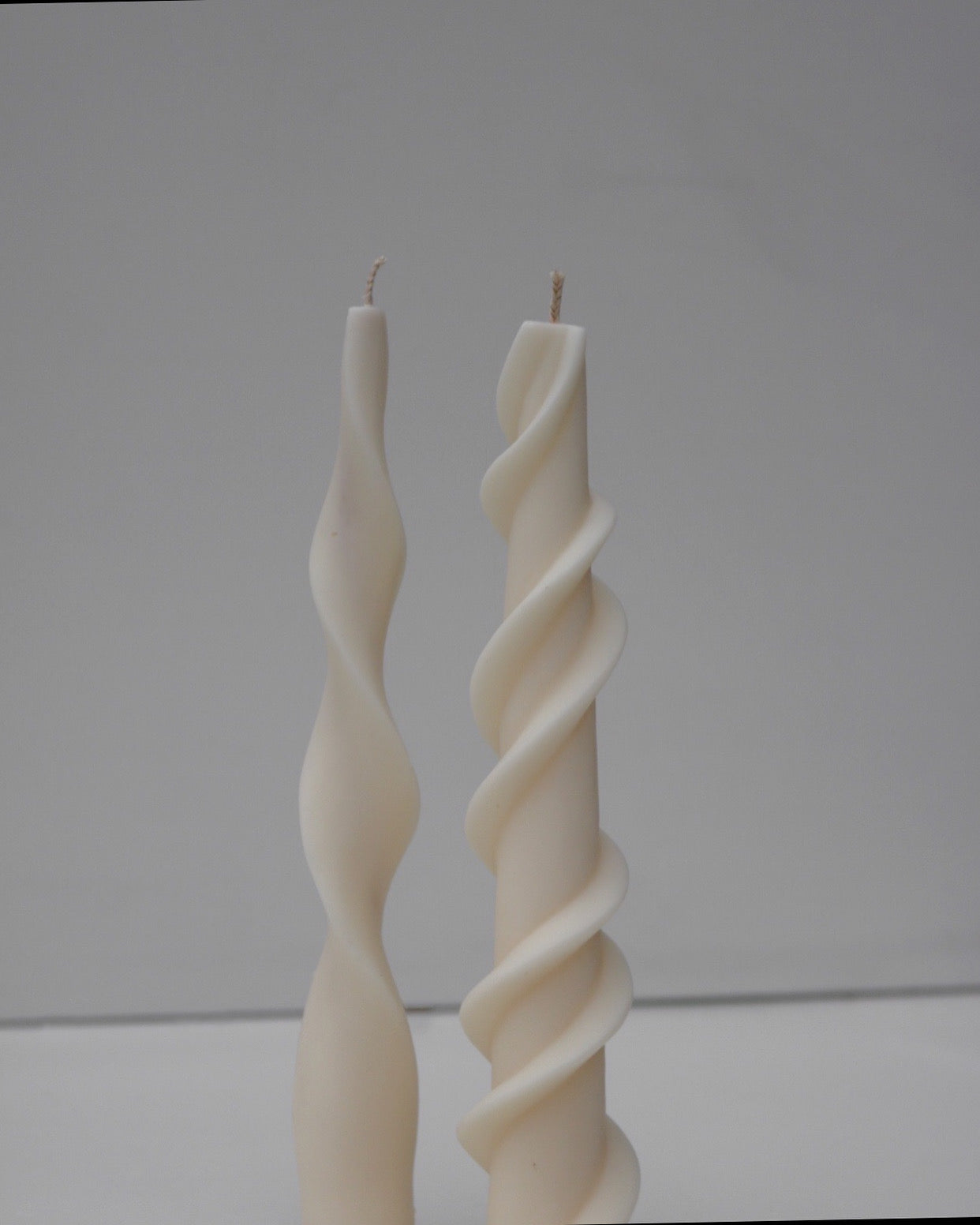 Elegant wave candlestick made from soy wax blend, showcasing a sculptural design perfect for home decor.