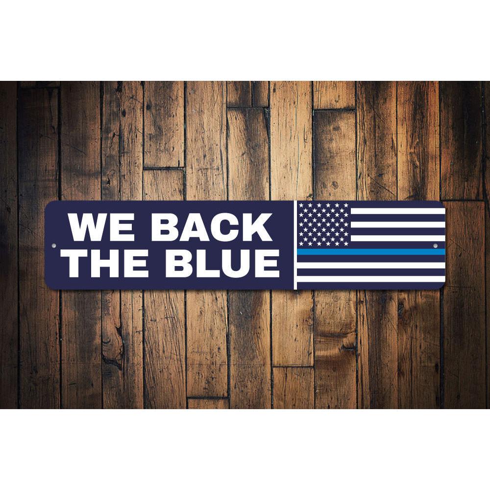 We Back The Blue Flag Sign made of durable aluminum, featuring a bold blue line design, perfect for home or outdoor display.