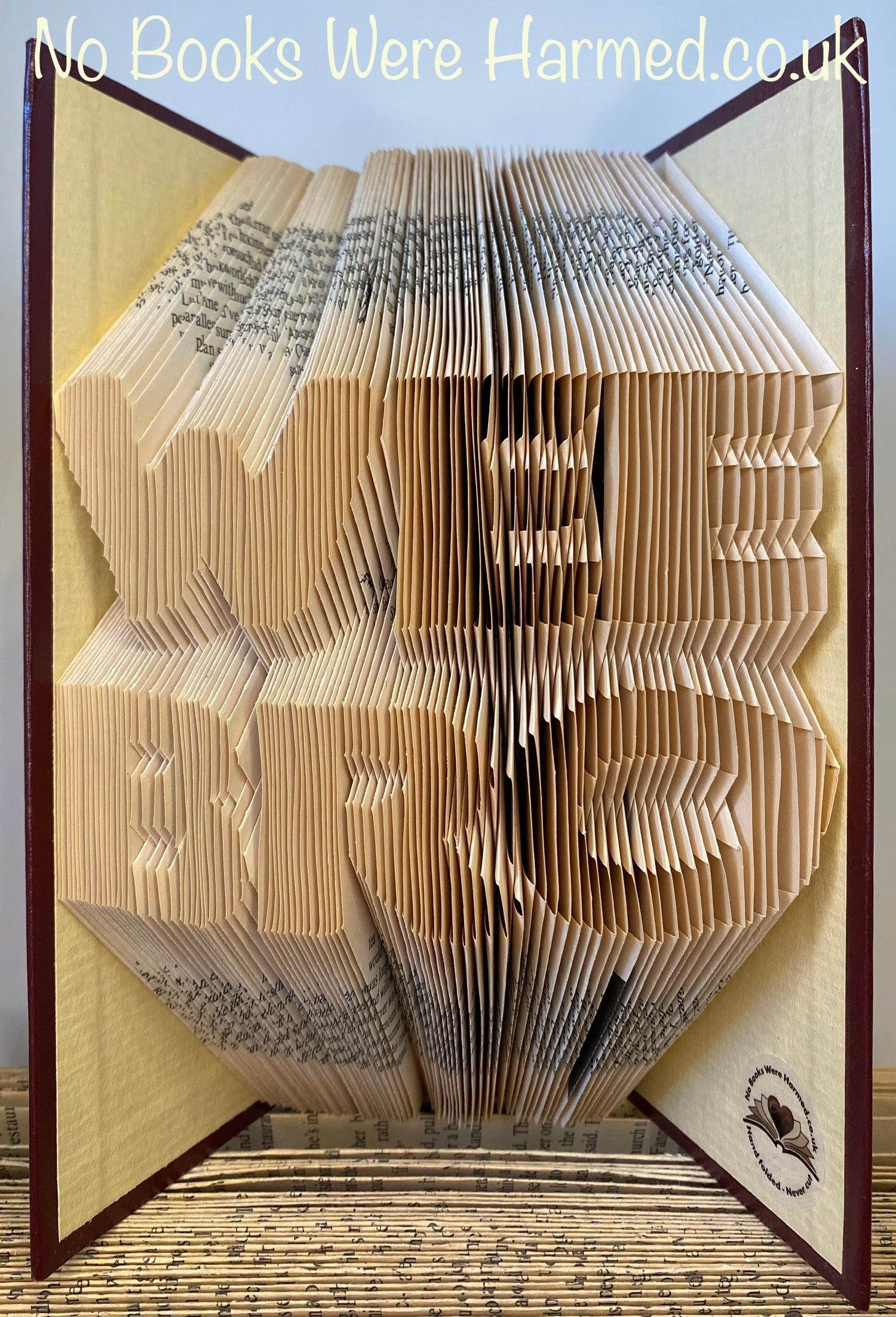 A handcrafted art piece made from vintage book pages, showcasing intricate folds and unique design, perfect for book lovers.