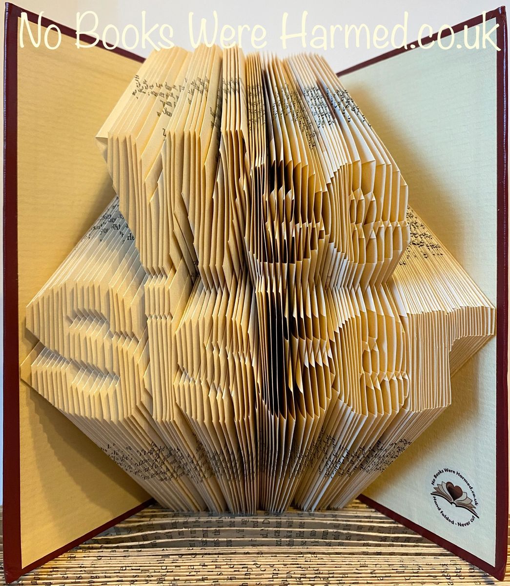 A unique piece of art made from hand-folded pages of vintage books, showcasing intricate designs and textures.