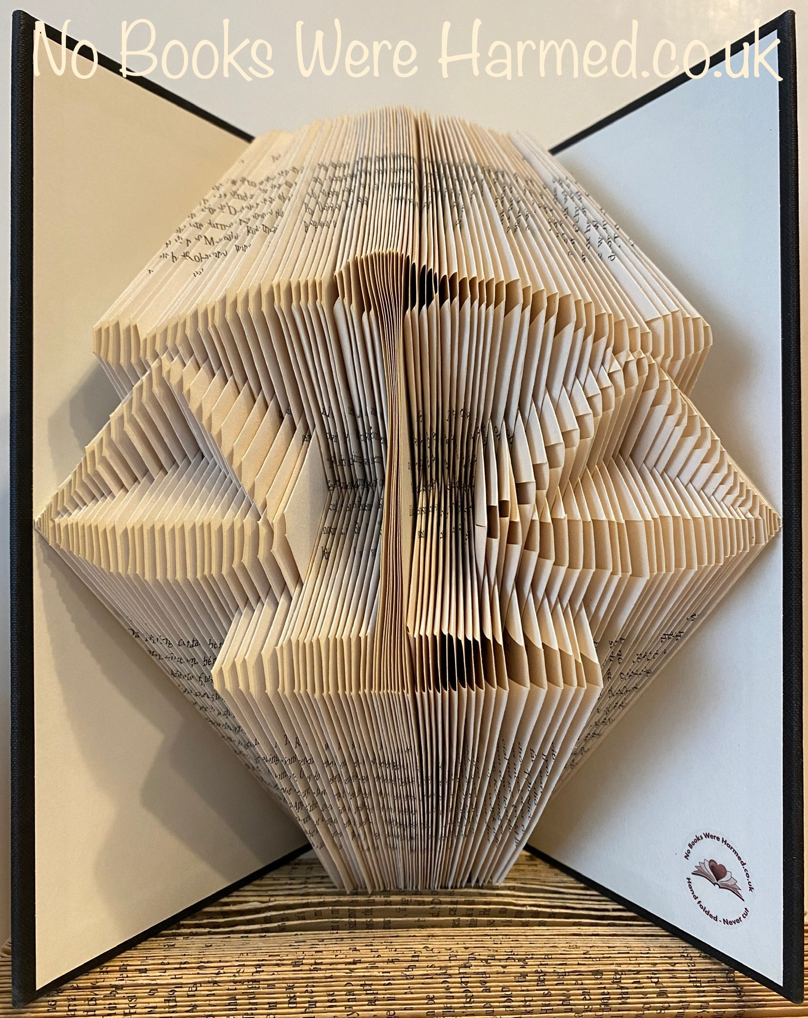 Handcrafted Weighing Scales of Justice art made from vintage book pages, showcasing intricate folds and unique colors.