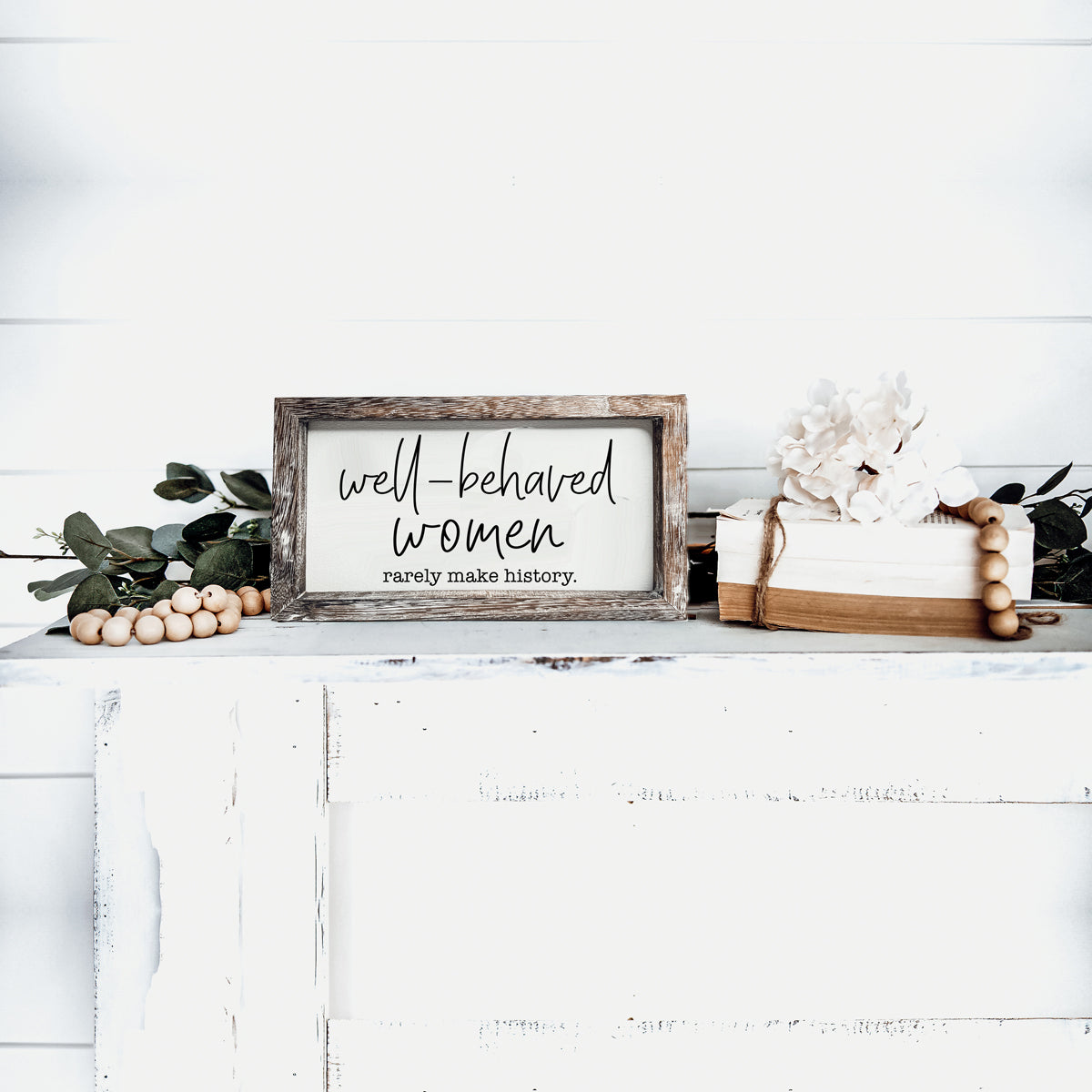 Well Behaved Women Sign made of durable Paulownia wood, featuring a stylish wooden frame with an empowering message.