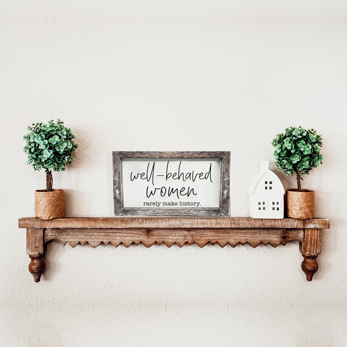 Well Behaved Women Sign made of durable Paulownia wood, featuring a stylish wooden frame with an empowering message.