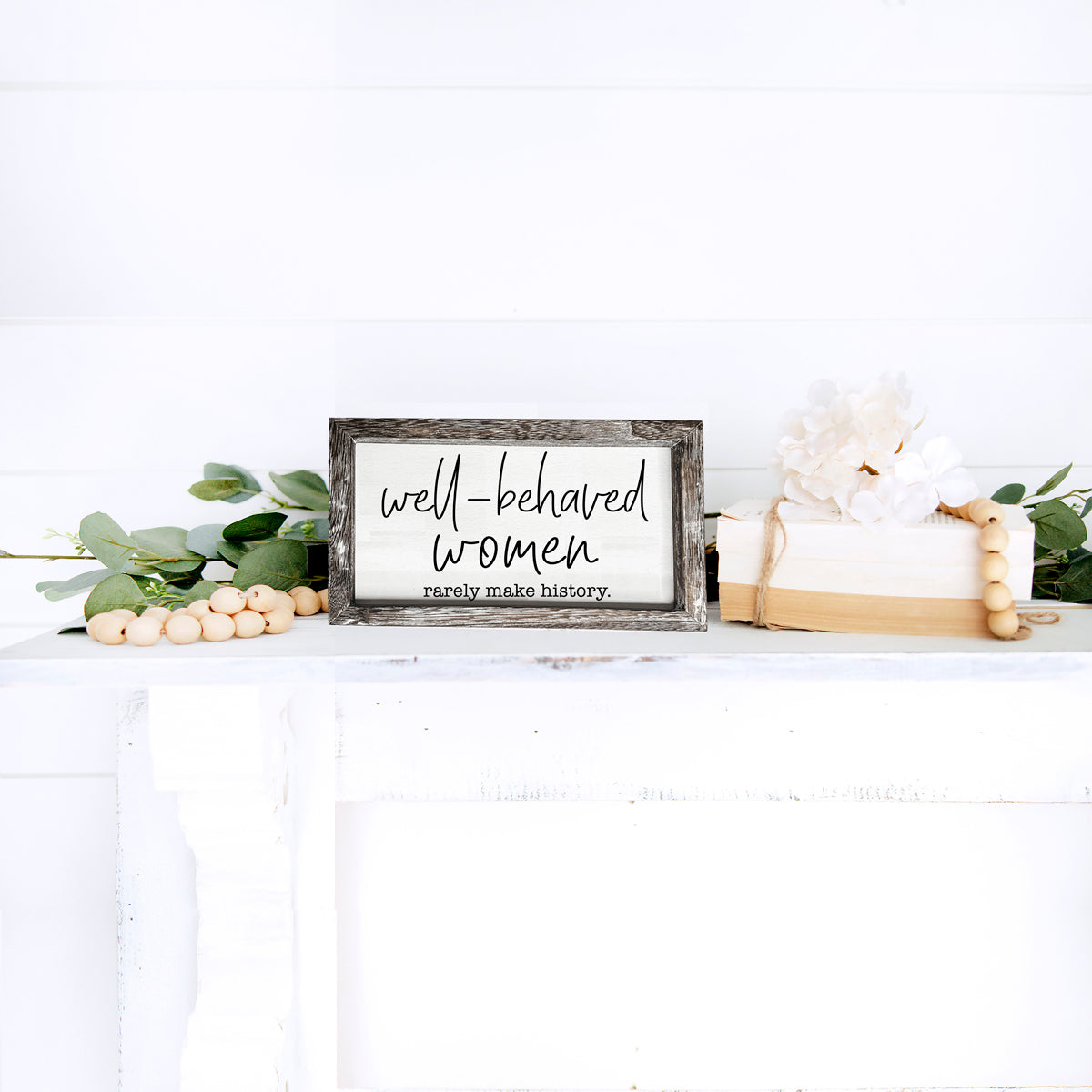 Well Behaved Women Sign made of durable Paulownia wood, featuring a stylish wooden frame with an empowering message.