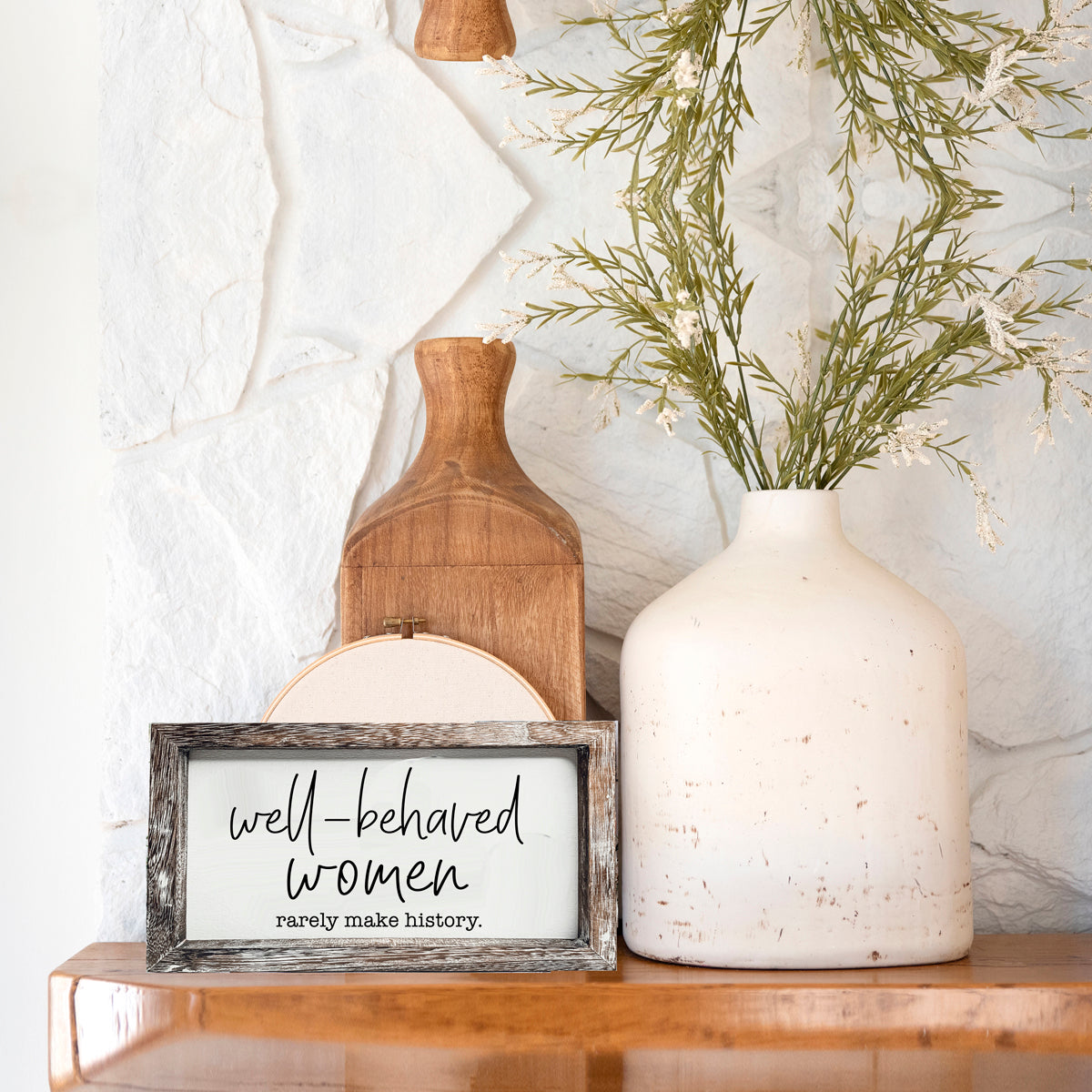 Well Behaved Women Sign made of durable Paulownia wood, featuring a stylish wooden frame with an empowering message.