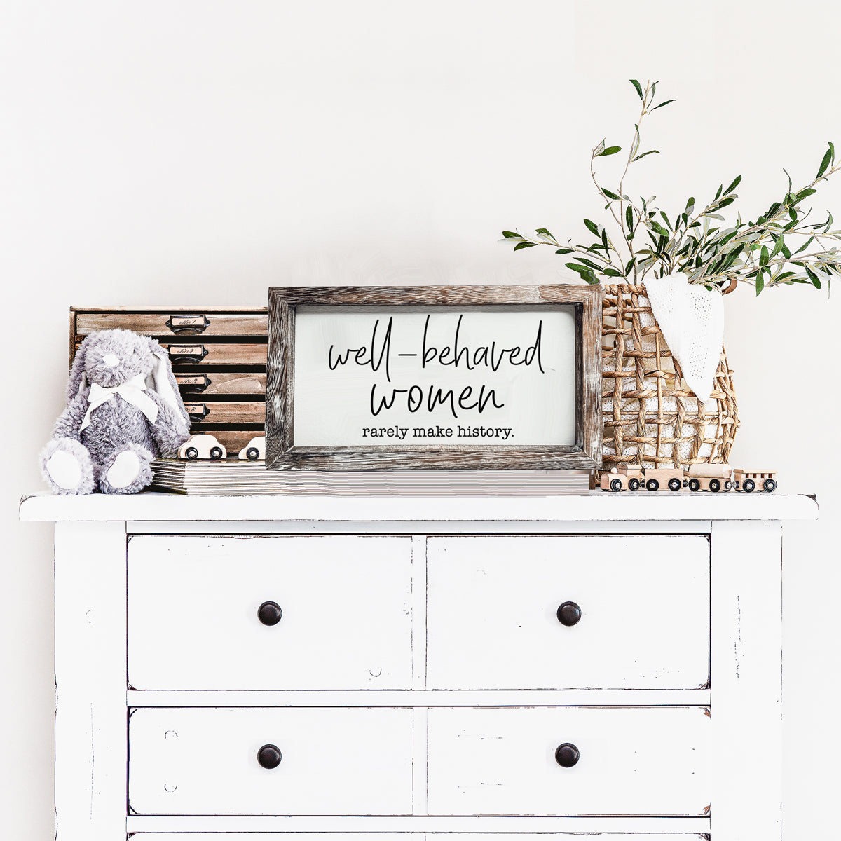 Well Behaved Women Sign made of durable Paulownia wood, featuring a stylish wooden frame with an empowering message.