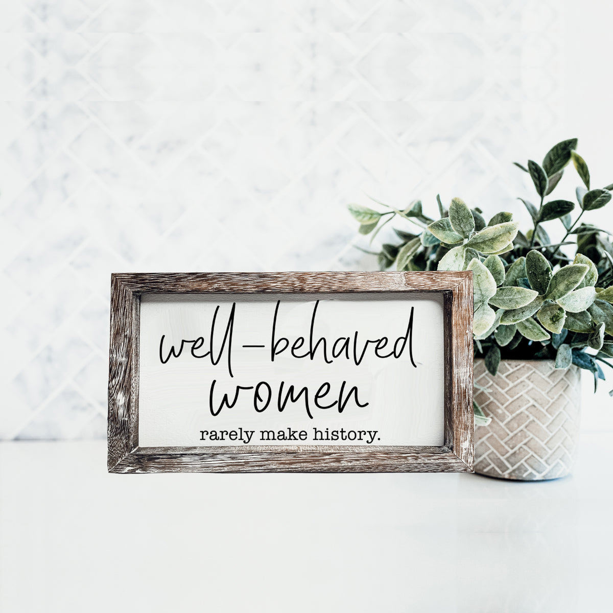 Well Behaved Women Sign made of durable Paulownia wood, featuring a stylish wooden frame with an empowering message.