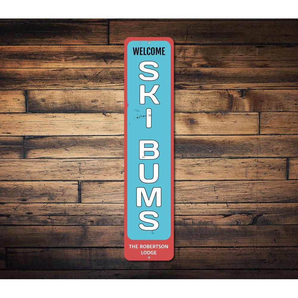 Welcome Ski Bums Vertical Sign made of aluminum, featuring a ski-themed design, perfect for ski lodges and winter sports enthusiasts.