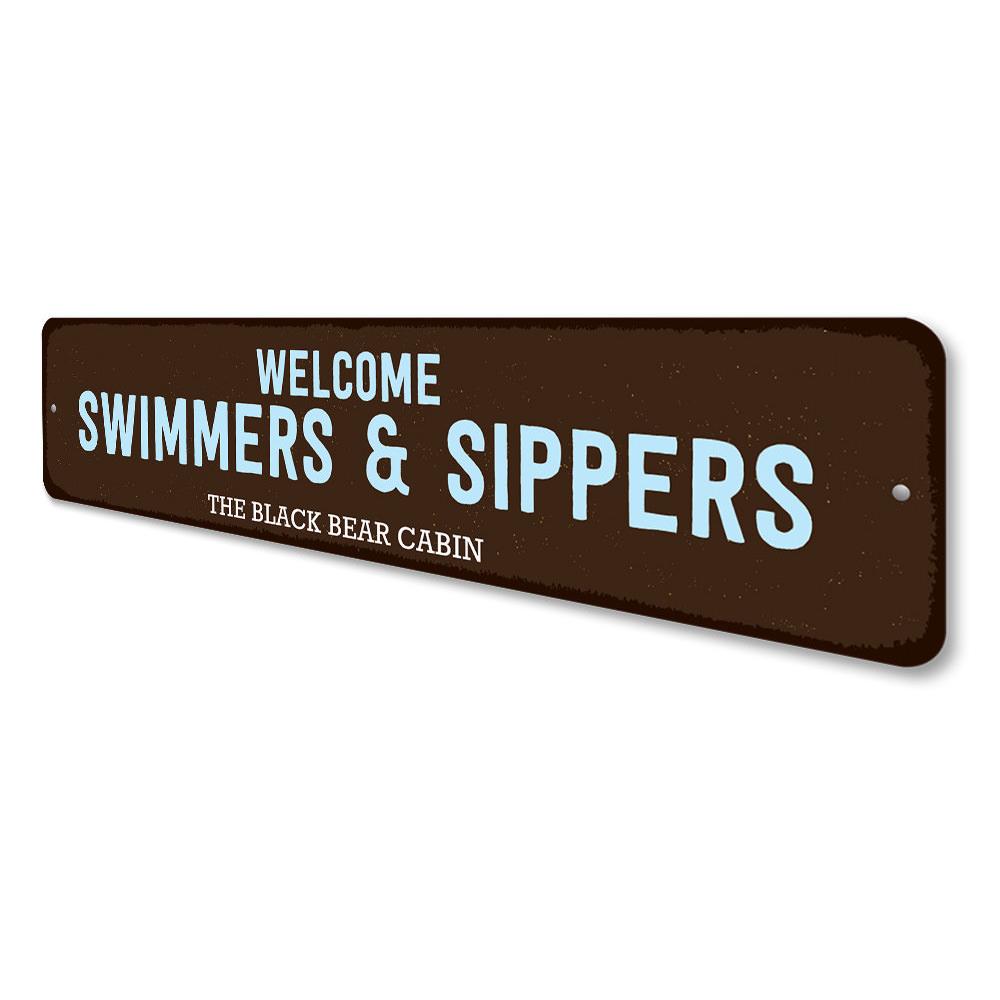 Welcome Swimmers & Sippers Sign made of durable aluminum, featuring a charming design perfect for lakehouses.