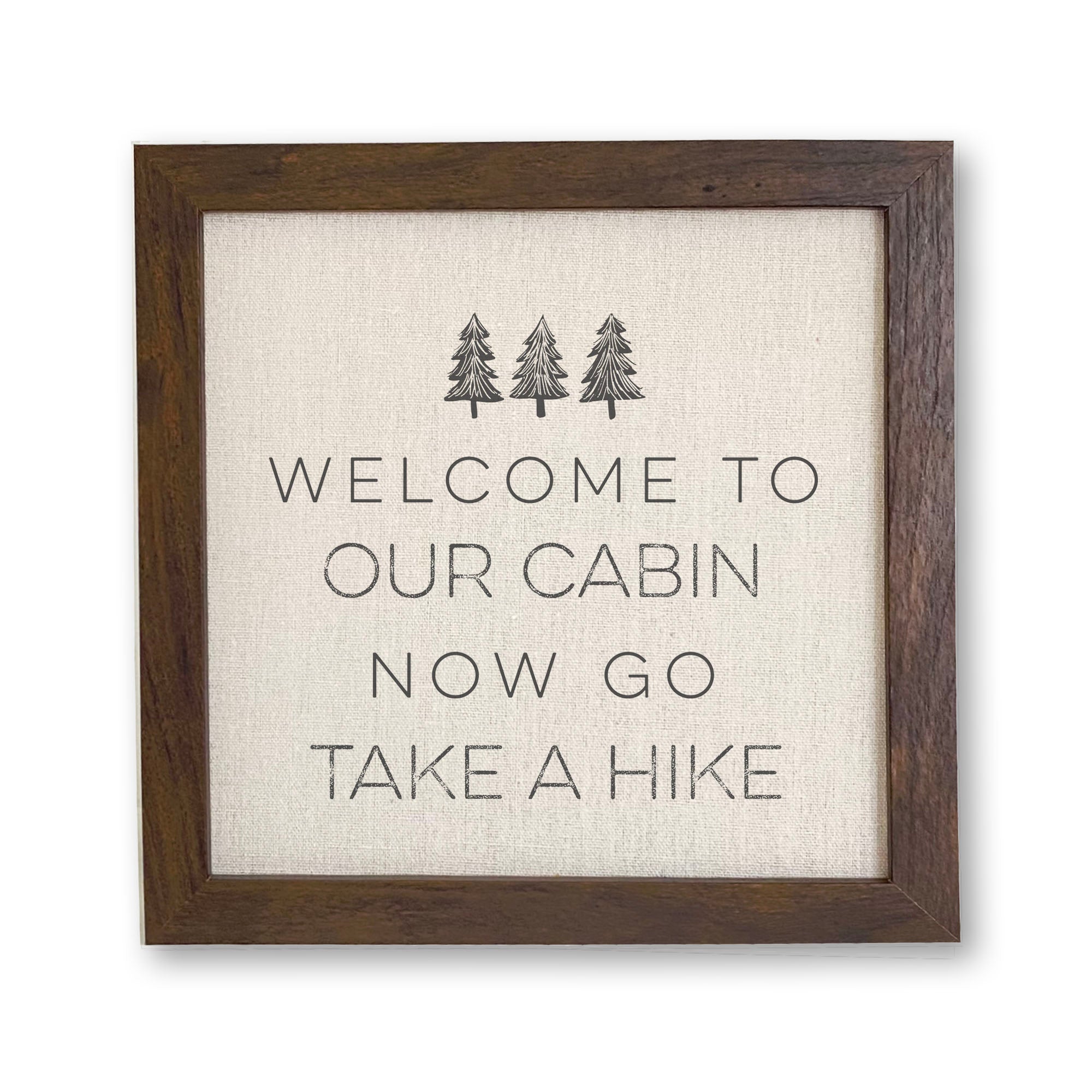 Framed sign featuring a cabin design with a wood frame, suitable for shelf or wall display.