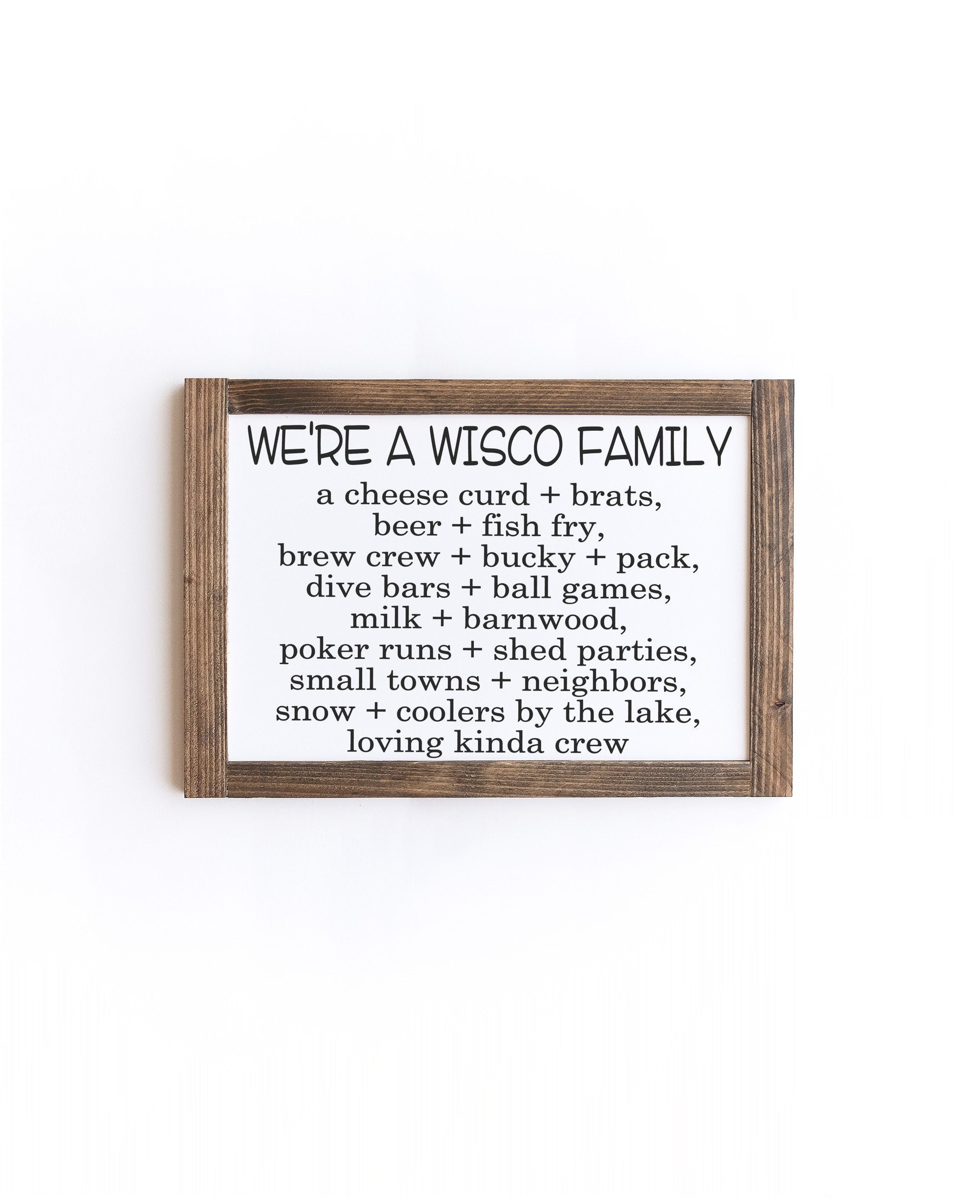 We're A Wisco Family Wood Sign, handcrafted from 100% wood with a matte white background and painted lettering, showcasing rustic charm.