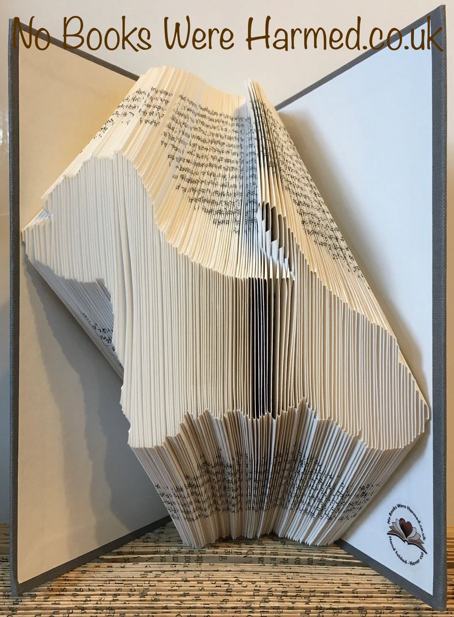 Handcrafted West Highland White Terrier art made from vintage book pages, showcasing intricate folds and unique design.