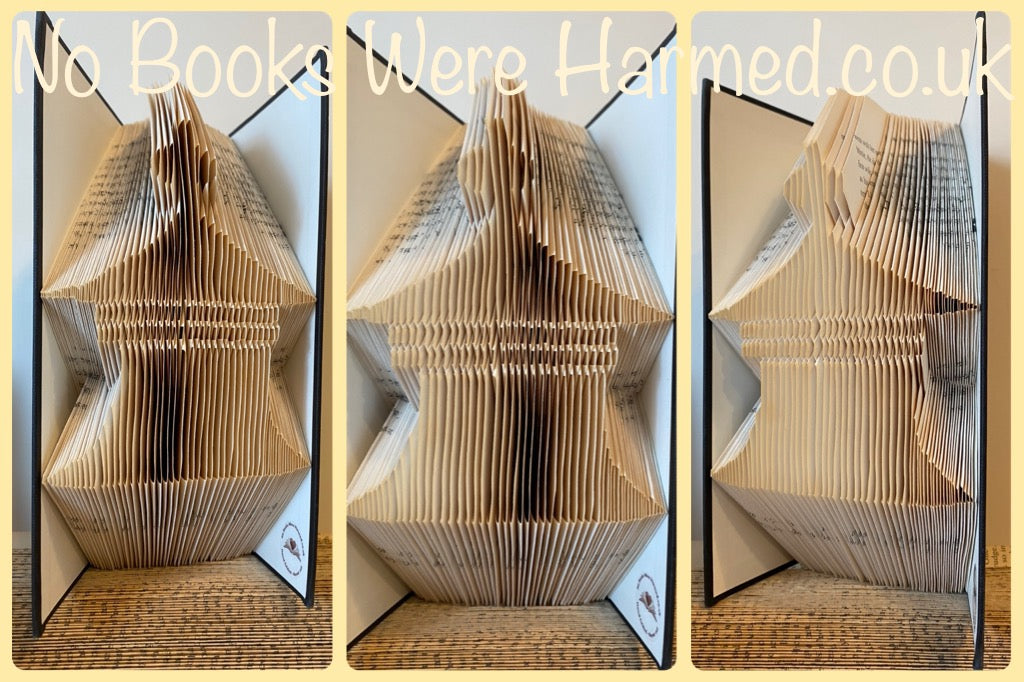 Hand-folded book art sculpture resembling a pagoda cupola, crafted from vintage books, showcasing intricate folds and unique textures.