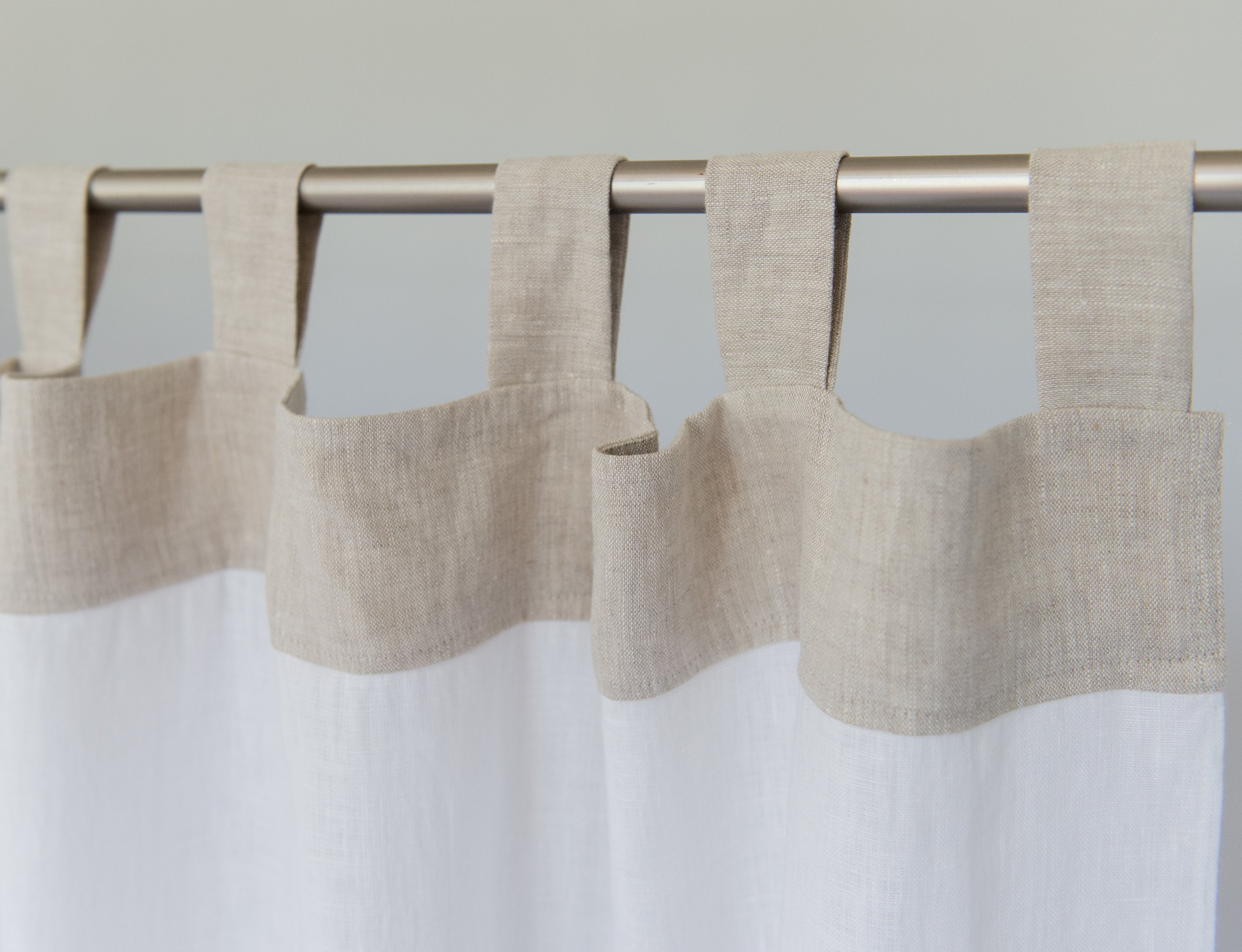 Elegant White and Natural Light linen curtains with tab tops, showcasing a stylish two-tone design for modern interiors.