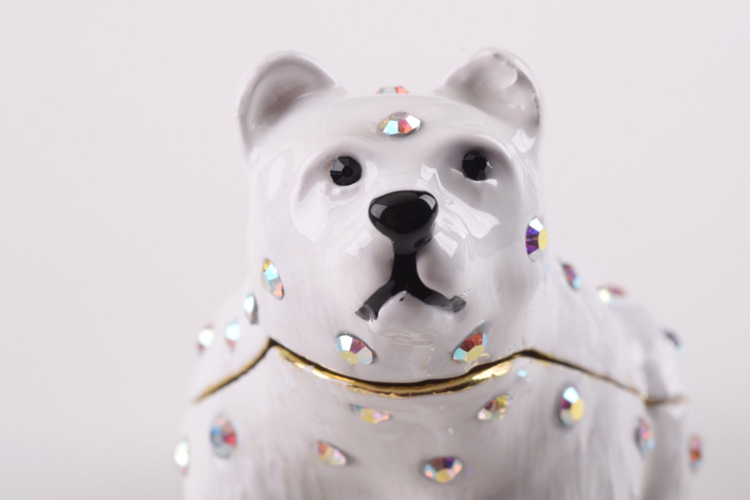 A beautifully handcrafted White Bear trinket box adorned with Austrian crystals and plated with 24K gold, showcasing intricate details and a secure magnetic closure.