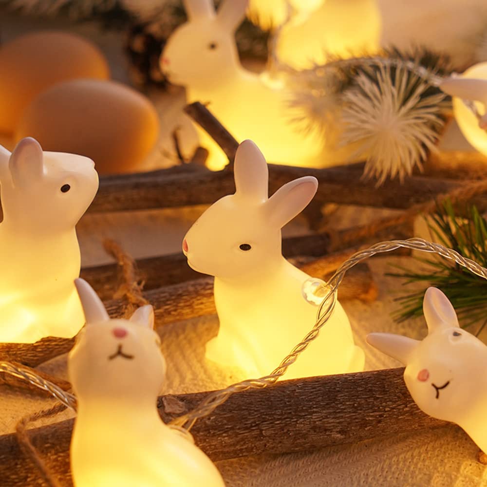 A string of 20 LED bunny-shaped lights on a transparent wire, glowing warmly, perfect for indoor decoration.