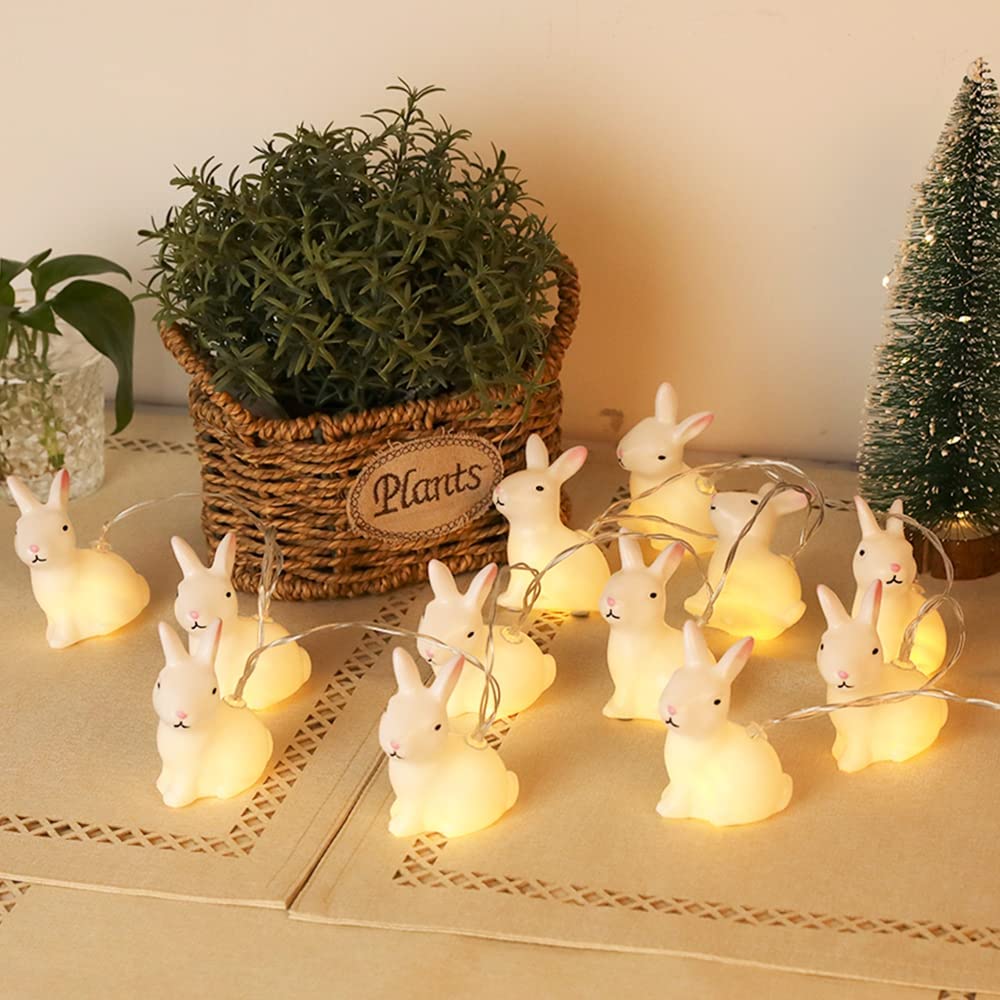 A string of 20 LED bunny-shaped lights on a transparent wire, glowing warmly, perfect for indoor decoration.