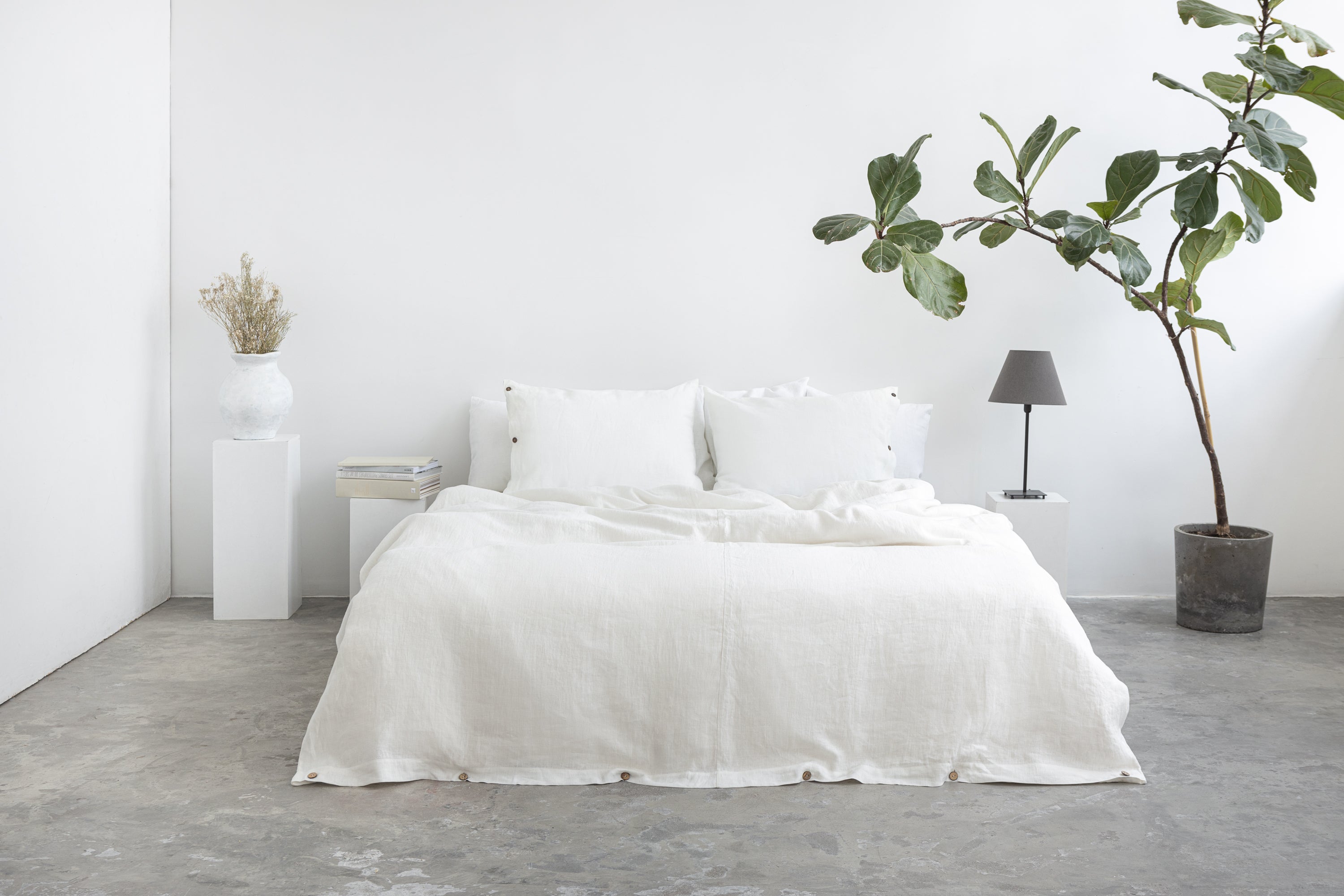 A luxurious white linen duvet cover featuring coconut buttons, showcasing its soft texture and elegant design.