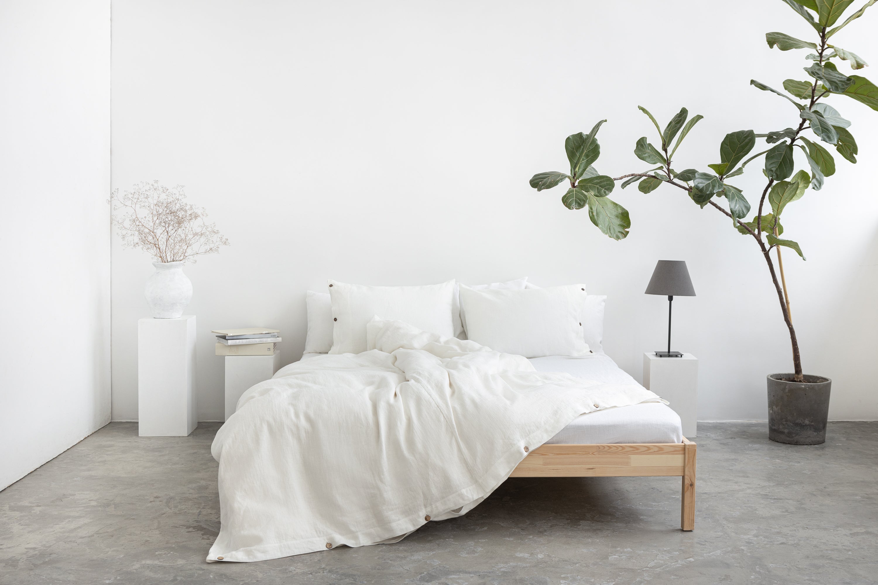 A luxurious white linen duvet cover featuring coconut buttons, showcasing its soft texture and elegant design.