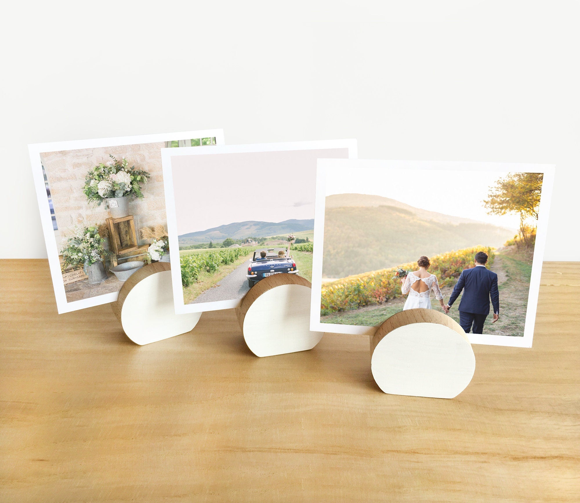 A handcrafted white moon card holder made from eco-friendly wood, designed to hold photos and art prints elegantly.