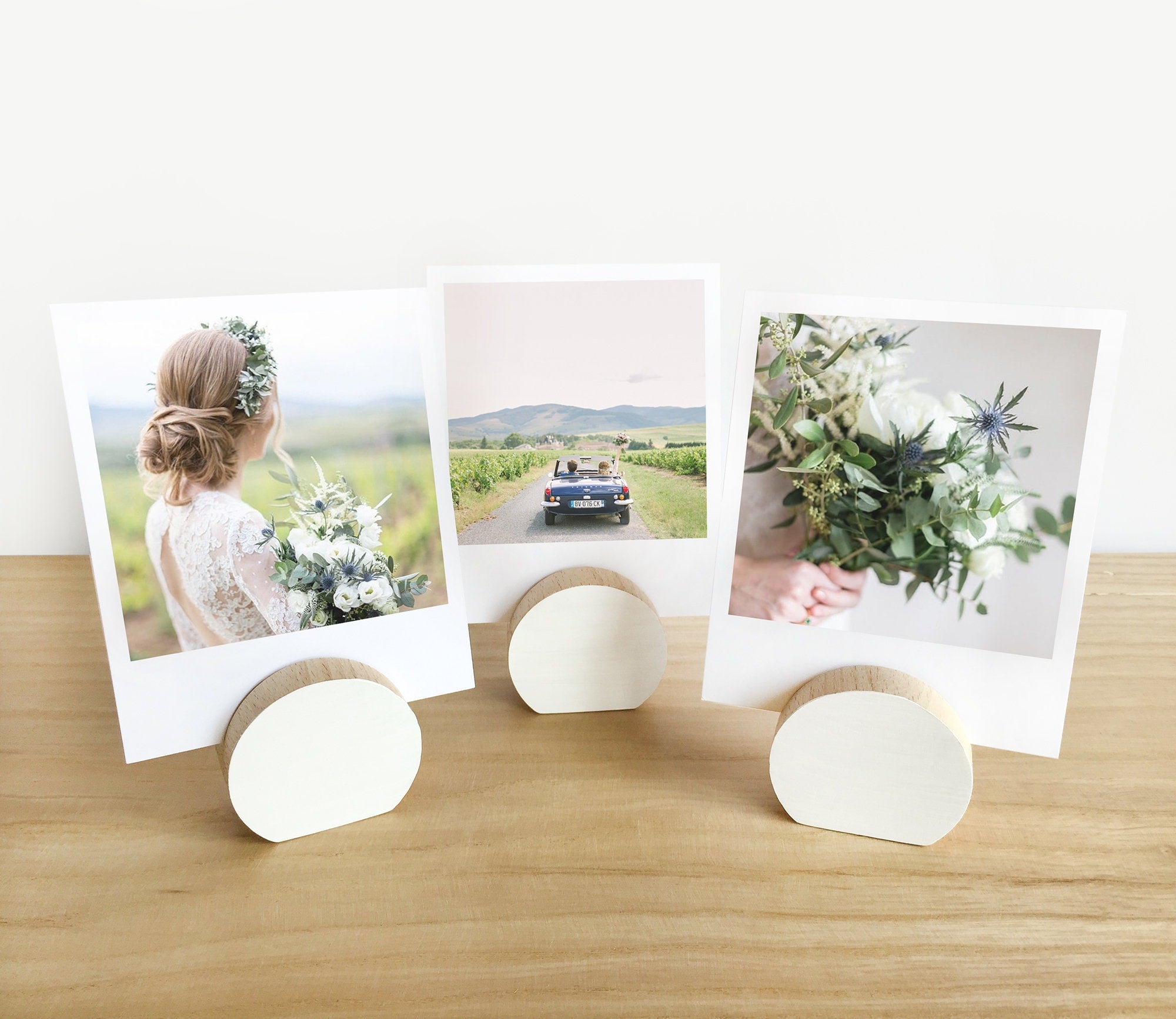 A handcrafted white moon card holder made from eco-friendly wood, designed to hold photos and art prints elegantly.