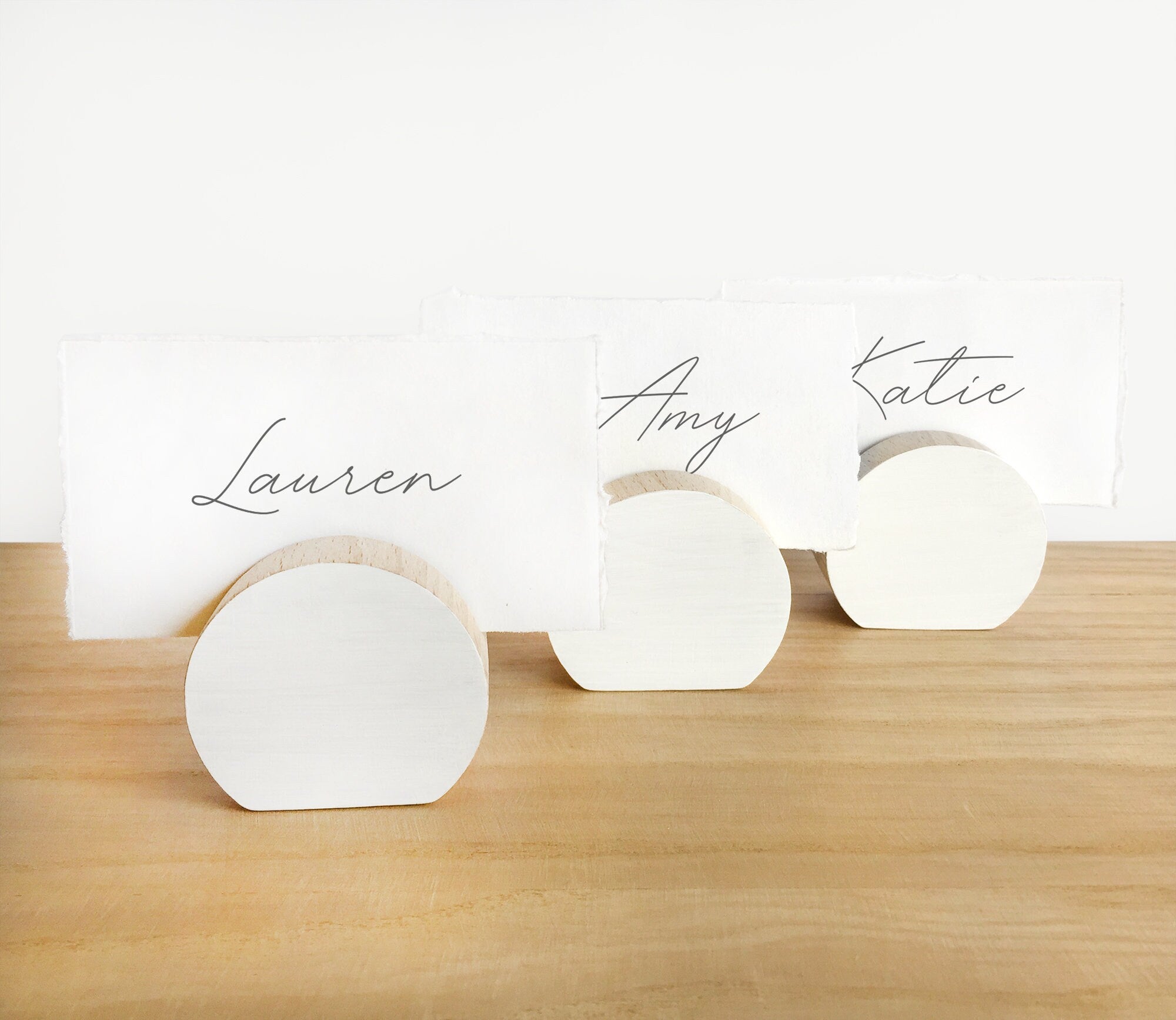 A handcrafted white moon card holder made from eco-friendly wood, designed to hold photos and art prints elegantly.