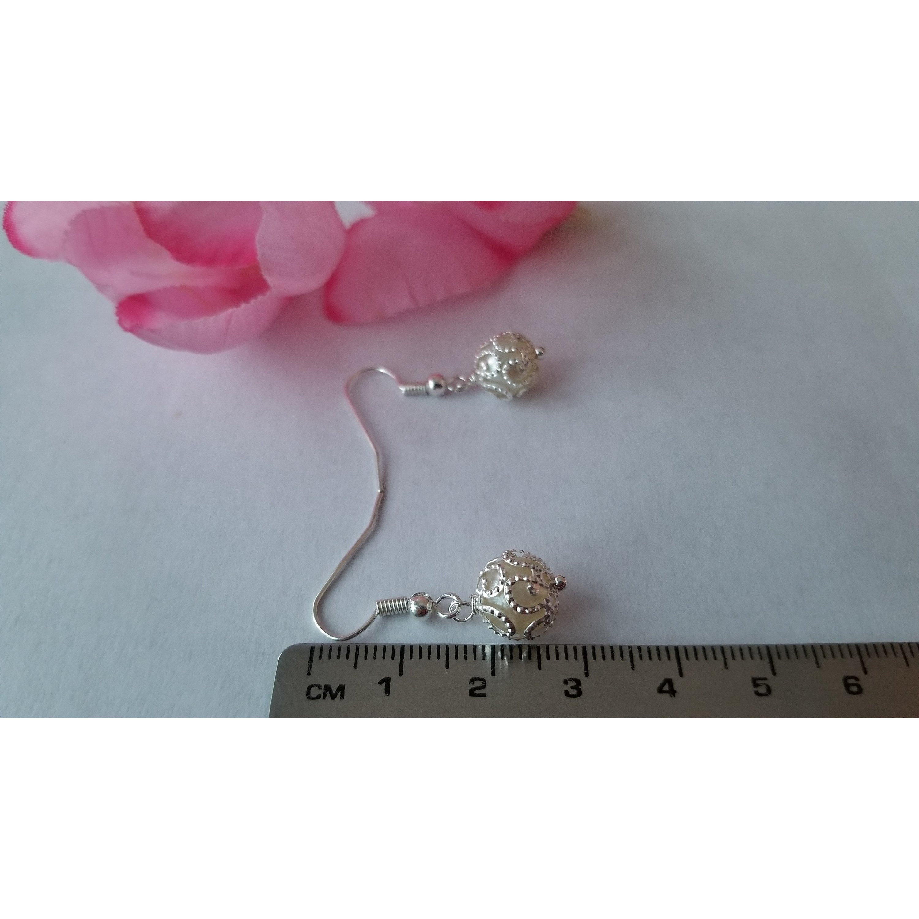 Elegant white pearl drop earrings made from stainless steel, showcasing a classic design with a lustrous finish.