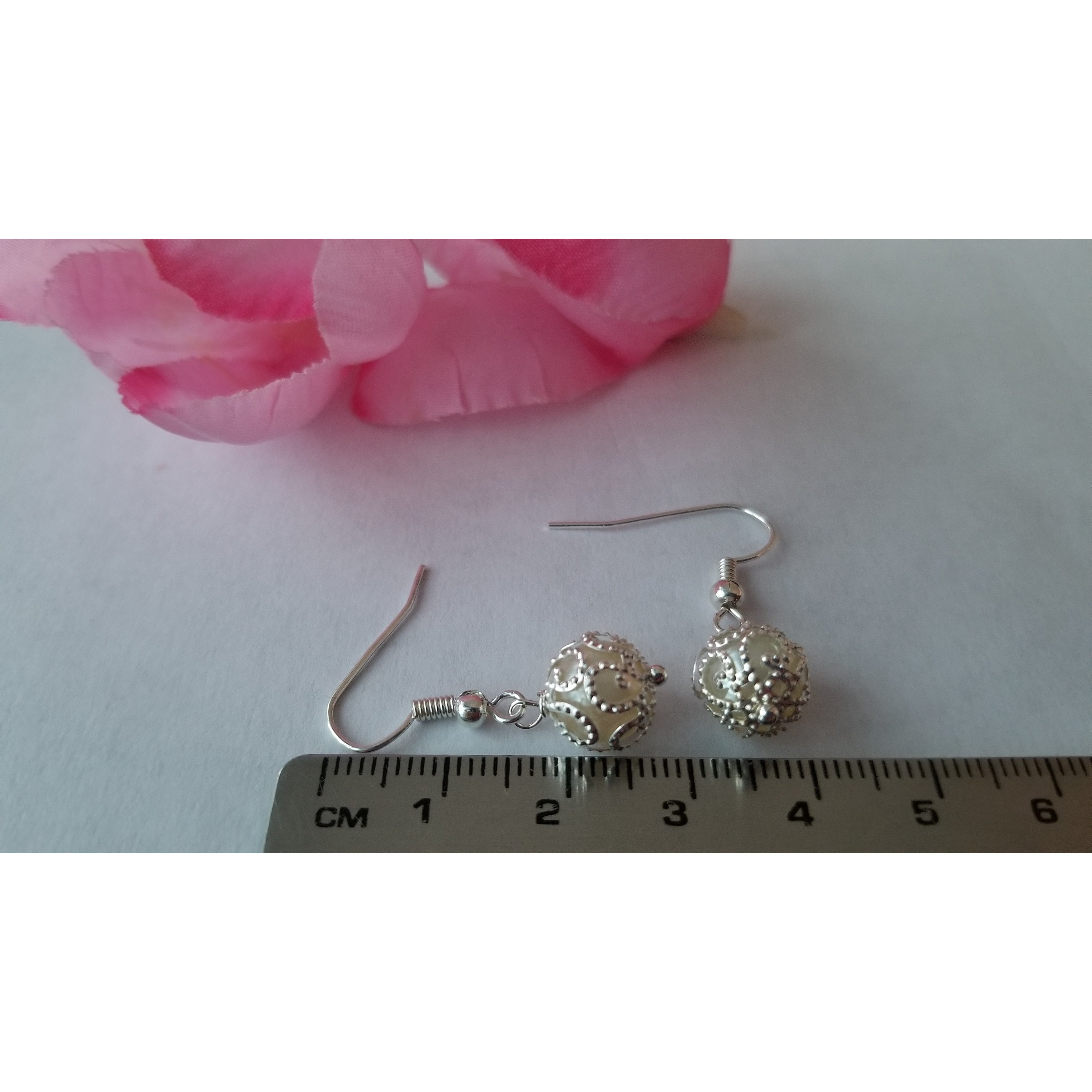 Elegant white pearl drop earrings made from stainless steel, showcasing a classic design with a lustrous finish.