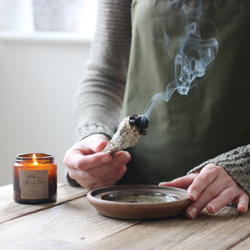 A White Sage Smudge Stick, approximately 11x3cm, used for cleansing and purifying rituals, emitting aromatic smoke.