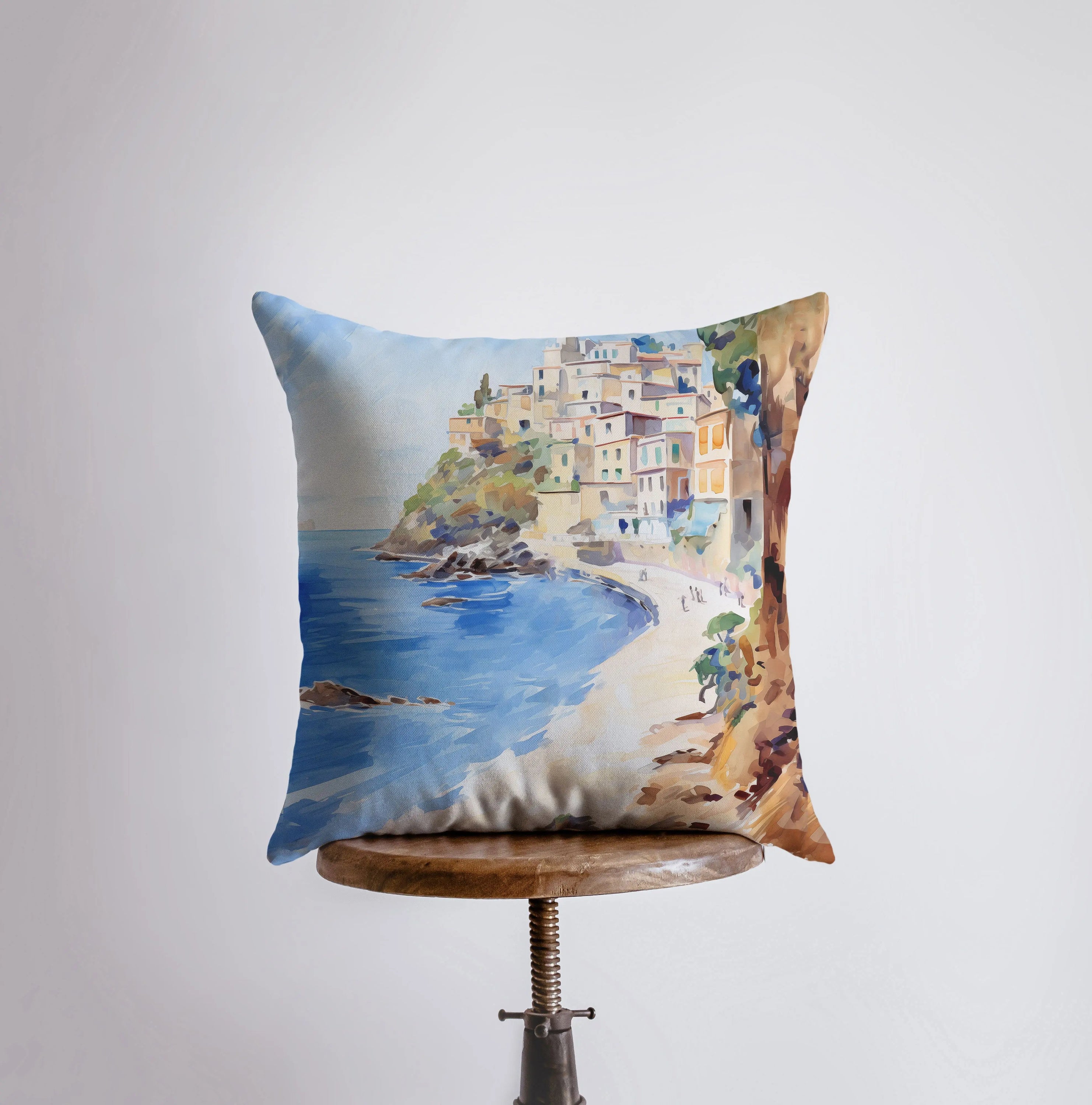 A beautifully crafted throw pillow featuring a white sandy beach and coastal city design, perfect for home decor.