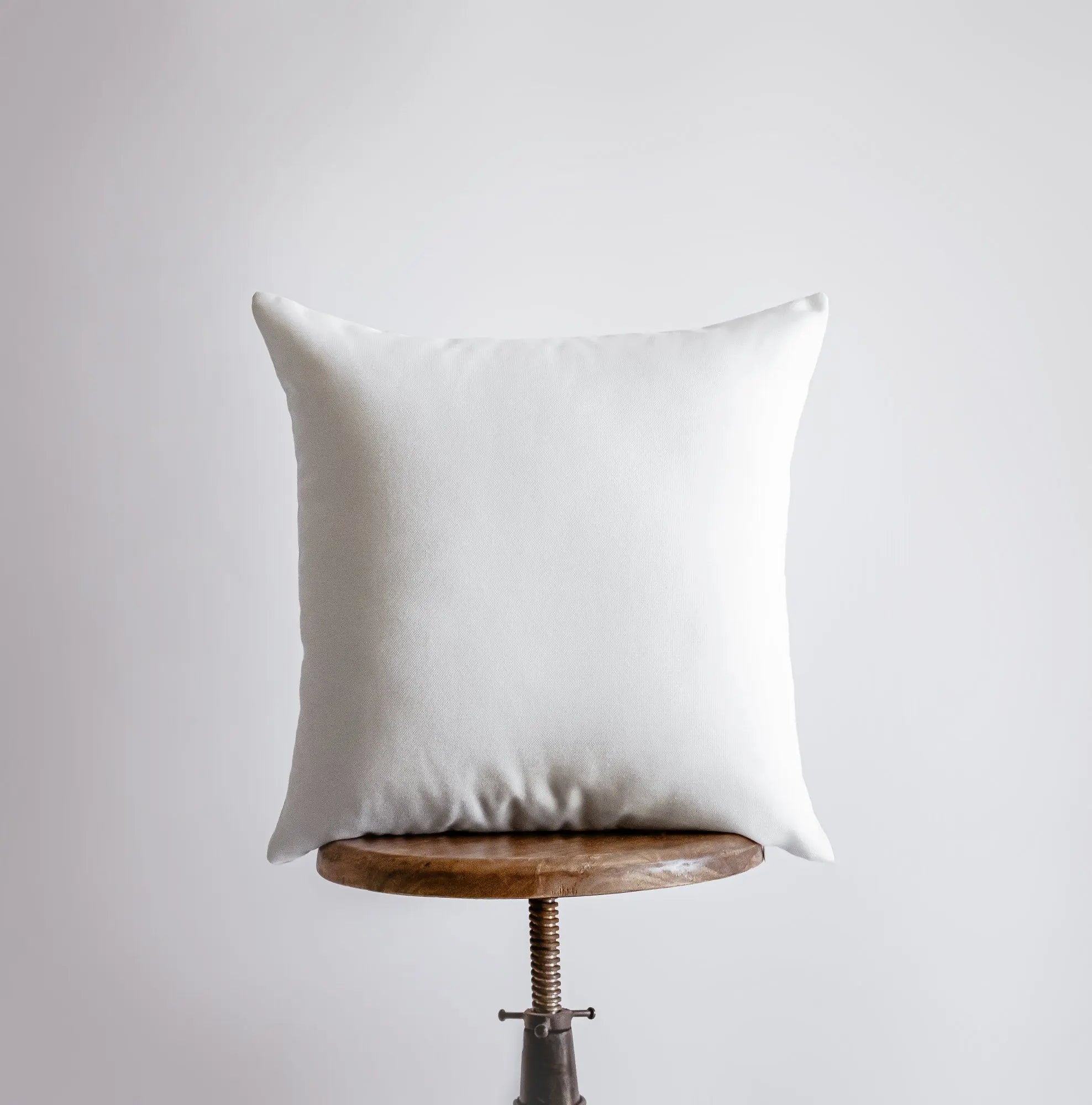 A beautifully crafted throw pillow featuring a white sandy beach and coastal city design, perfect for home decor.