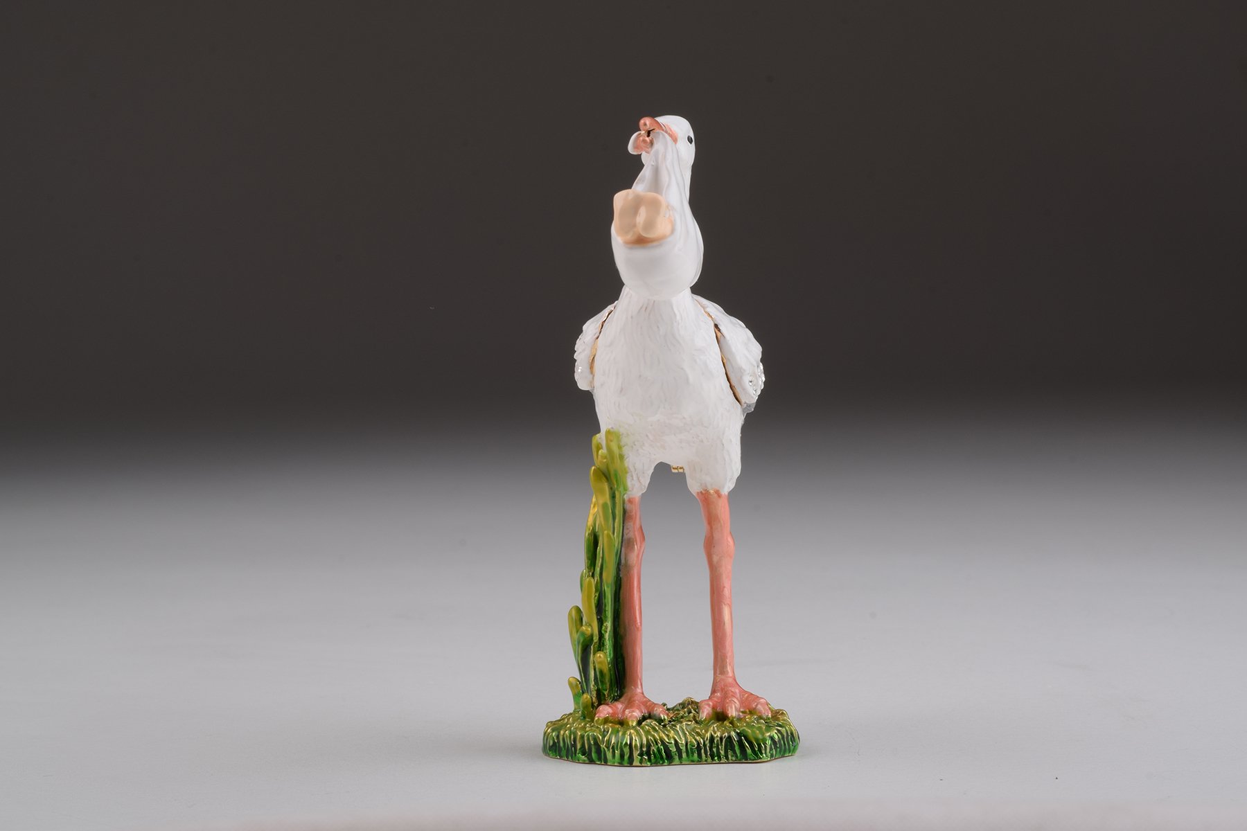 Handcrafted White Stork Carrying a Baby trinket box adorned with Austrian crystals and plated with 24K gold, showcasing exquisite craftsmanship.