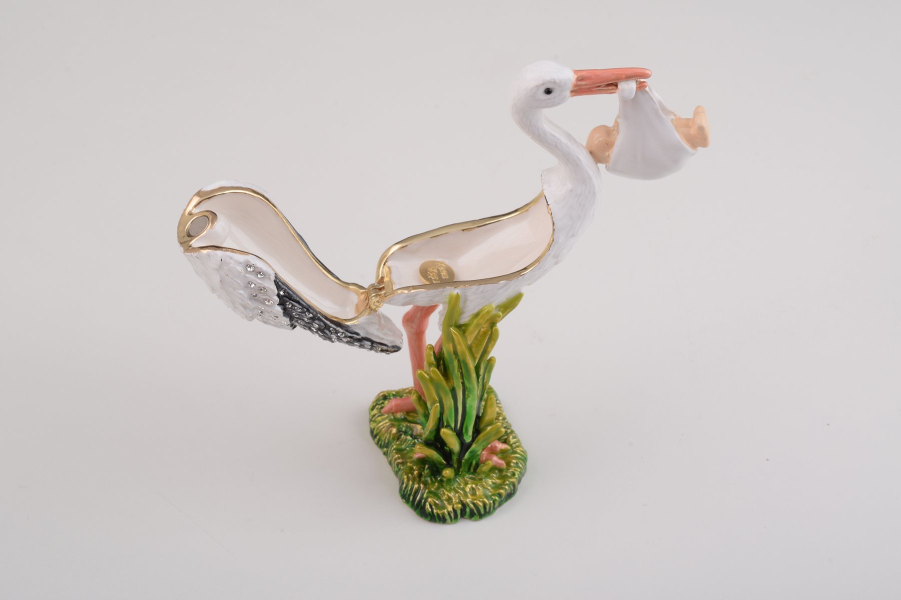 Handcrafted White Stork Carrying a Baby trinket box adorned with Austrian crystals and plated with 24K gold, showcasing exquisite craftsmanship.