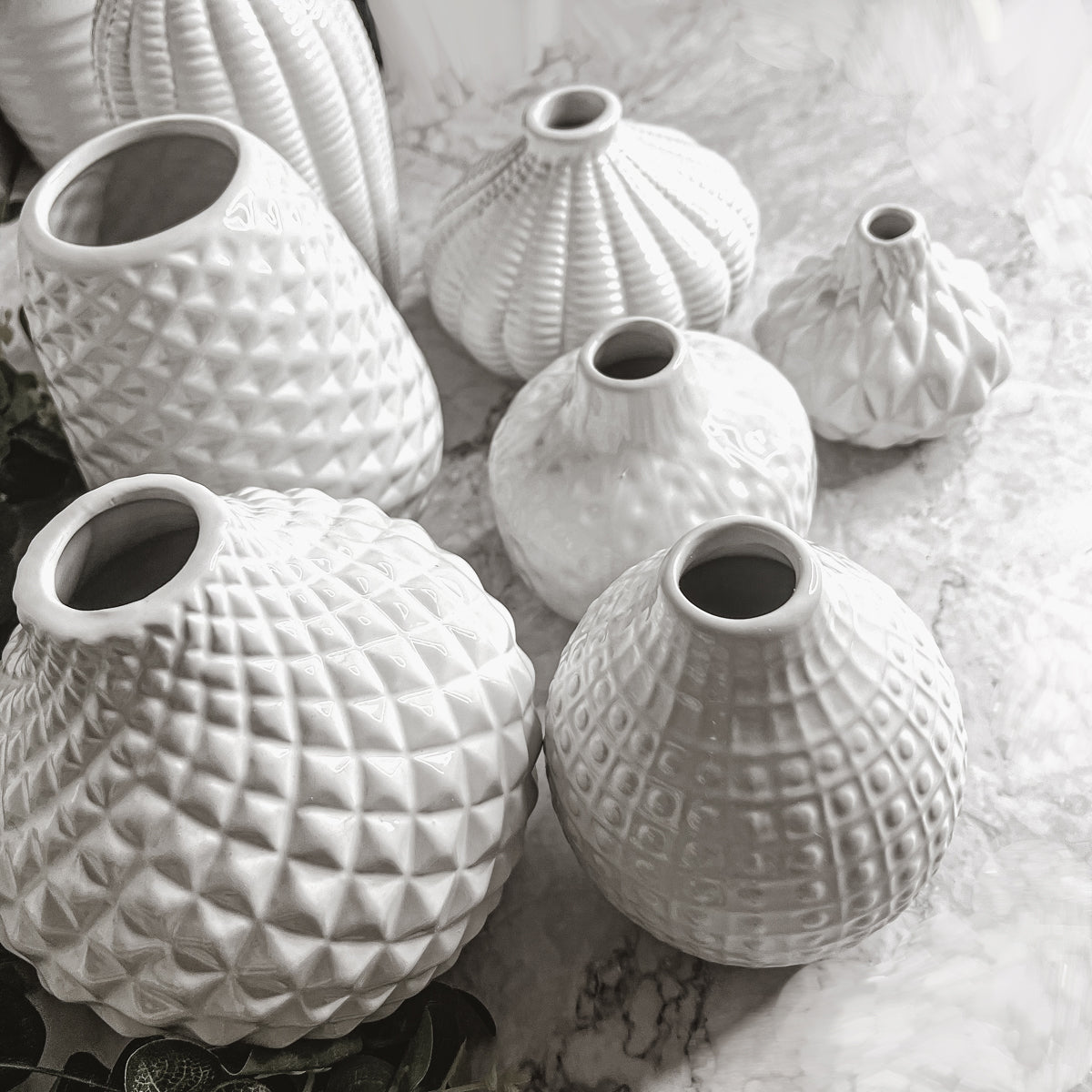 Elegant white ceramic Whitney Vases, artisan-made with exquisite detailing, perfect for flowers or home decor.