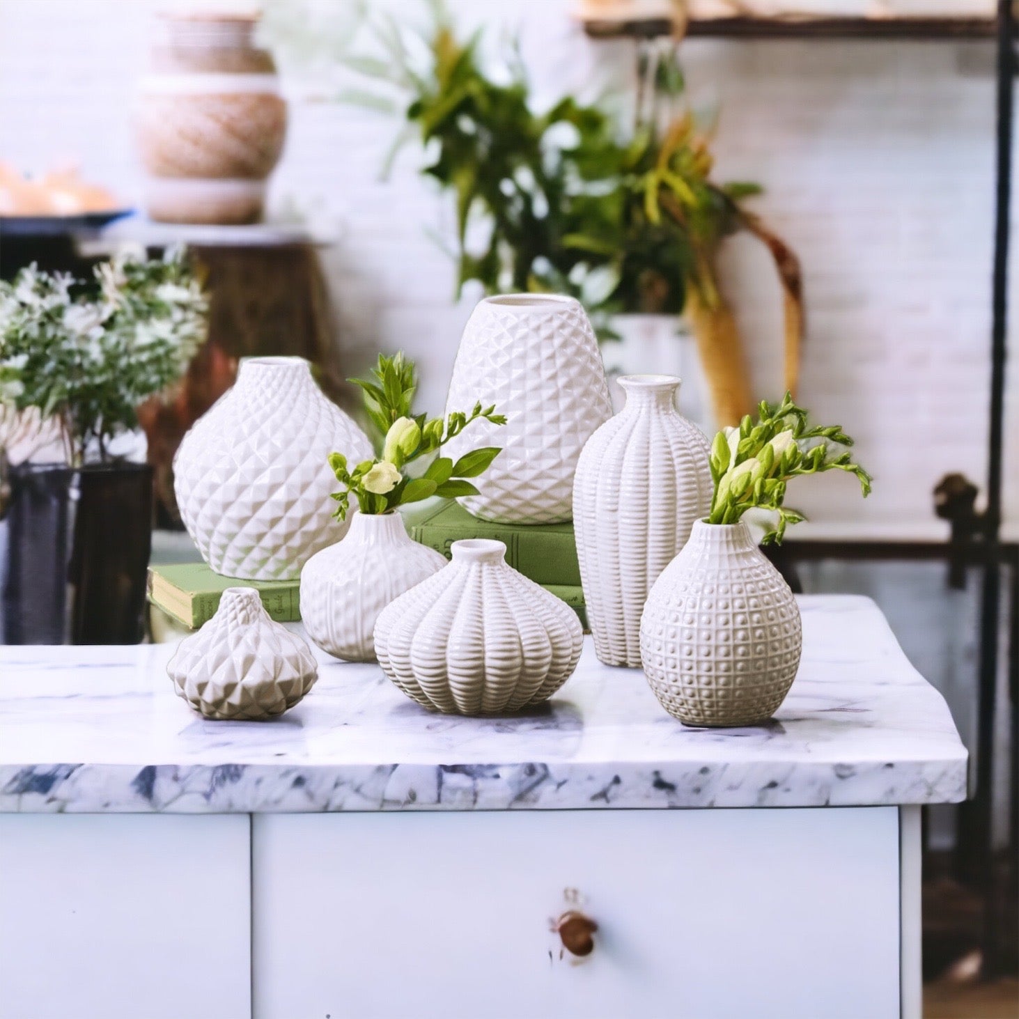 Elegant white ceramic Whitney Vases, artisan-made with exquisite detailing, perfect for flowers or home decor.