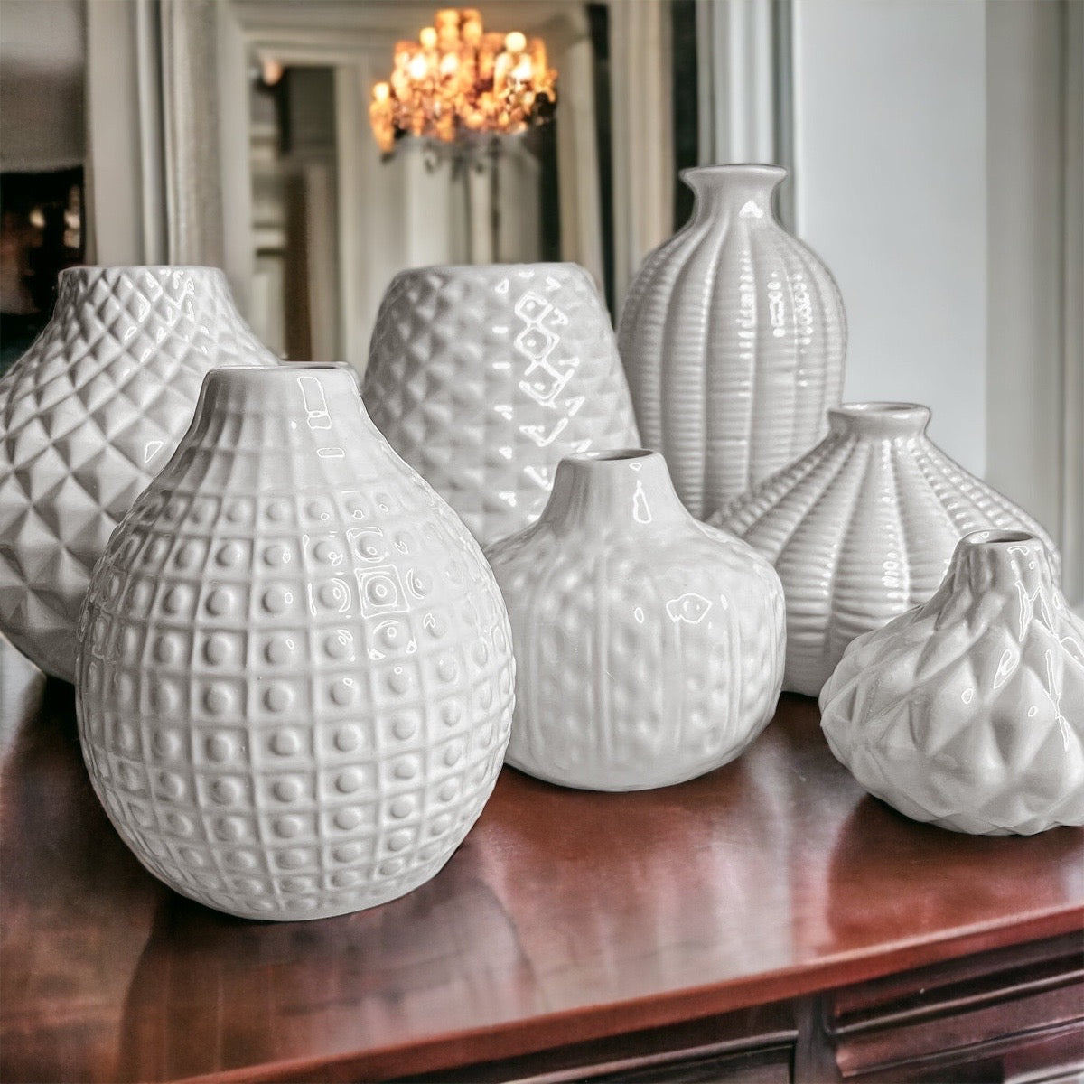 Elegant white ceramic Whitney Vases, artisan-made with exquisite detailing, perfect for flowers or home decor.