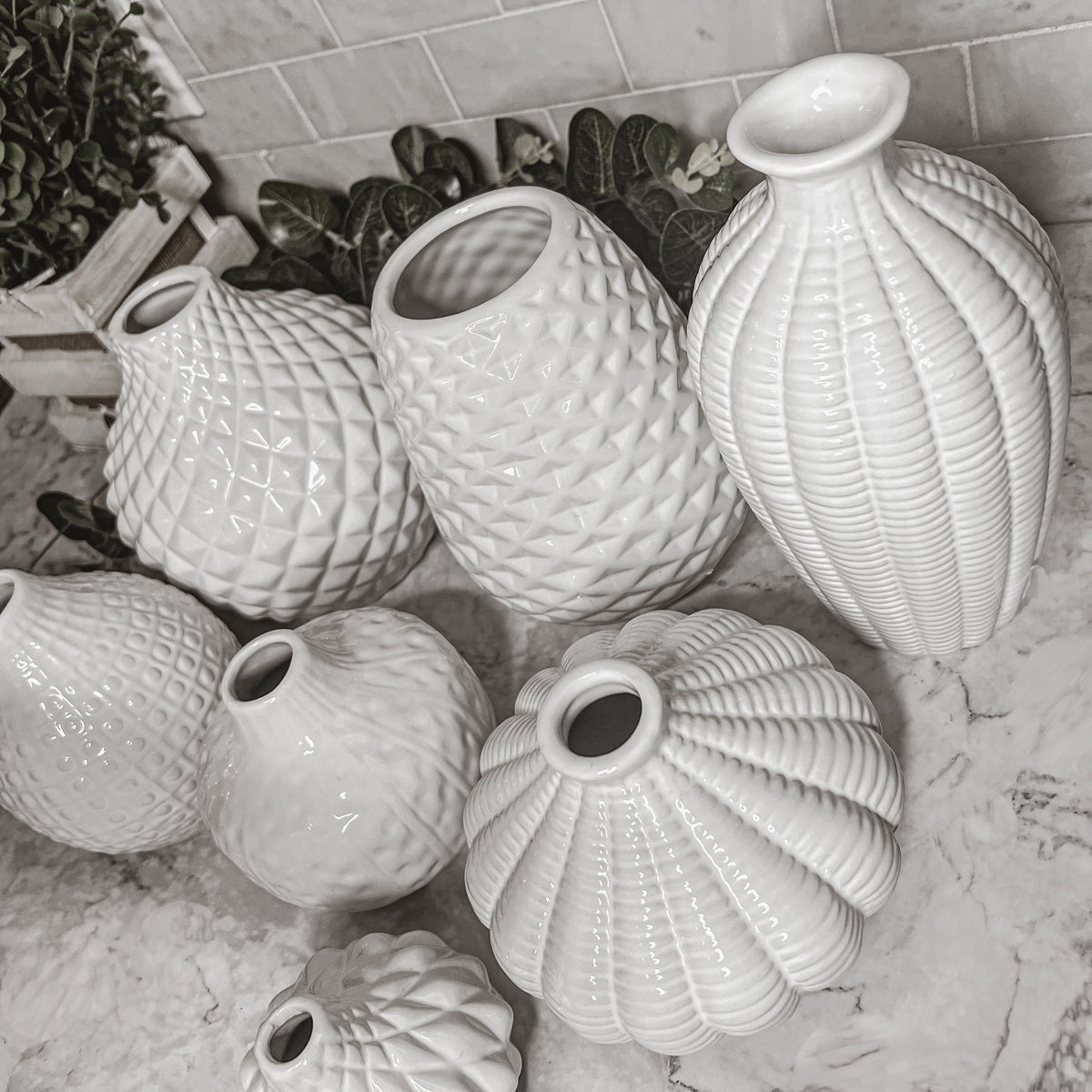 Elegant white ceramic Whitney Vases, artisan-made with exquisite detailing, perfect for flowers or home decor.