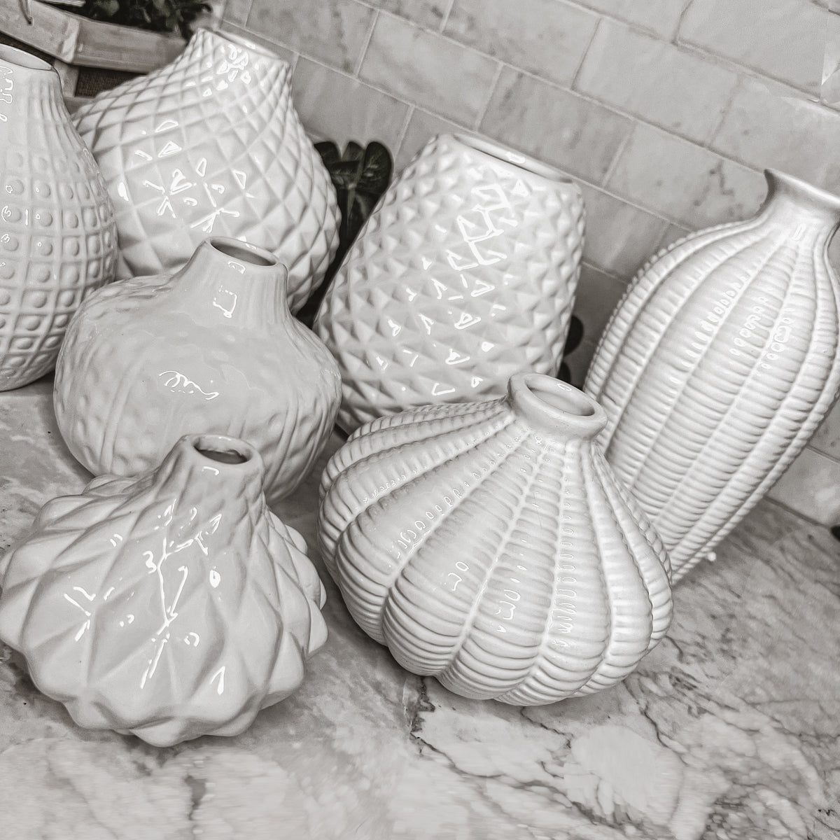 Elegant white ceramic Whitney Vases, artisan-made with exquisite detailing, perfect for flowers or home decor.