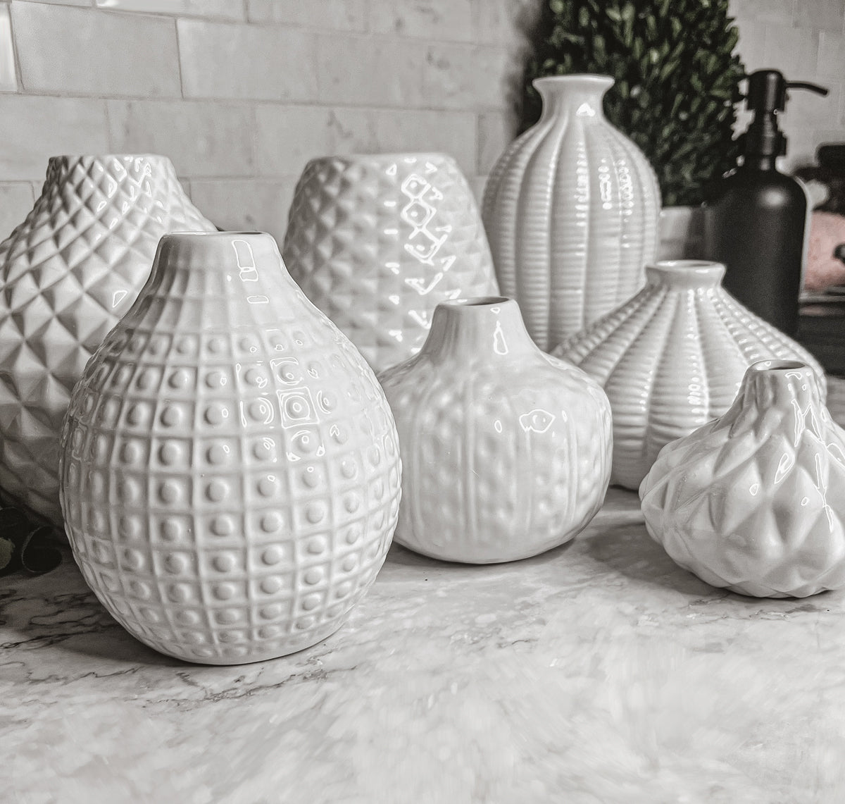 Elegant white ceramic Whitney Vases, artisan-made with exquisite detailing, perfect for flowers or home decor.