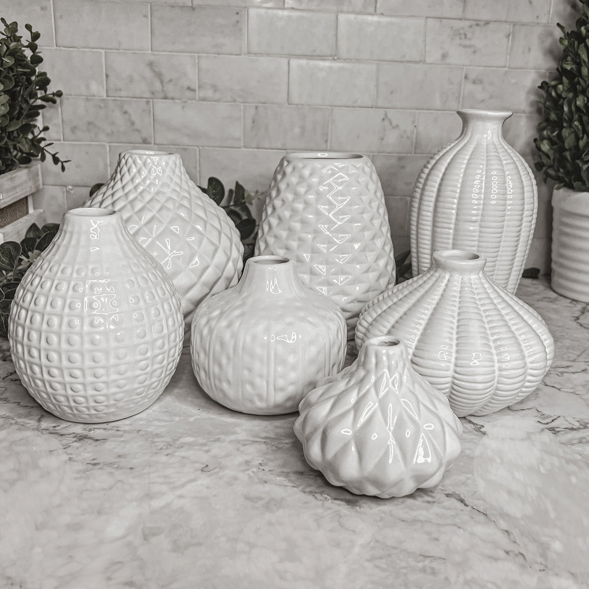 Elegant white ceramic Whitney Vases, artisan-made with exquisite detailing, perfect for flowers or home decor.